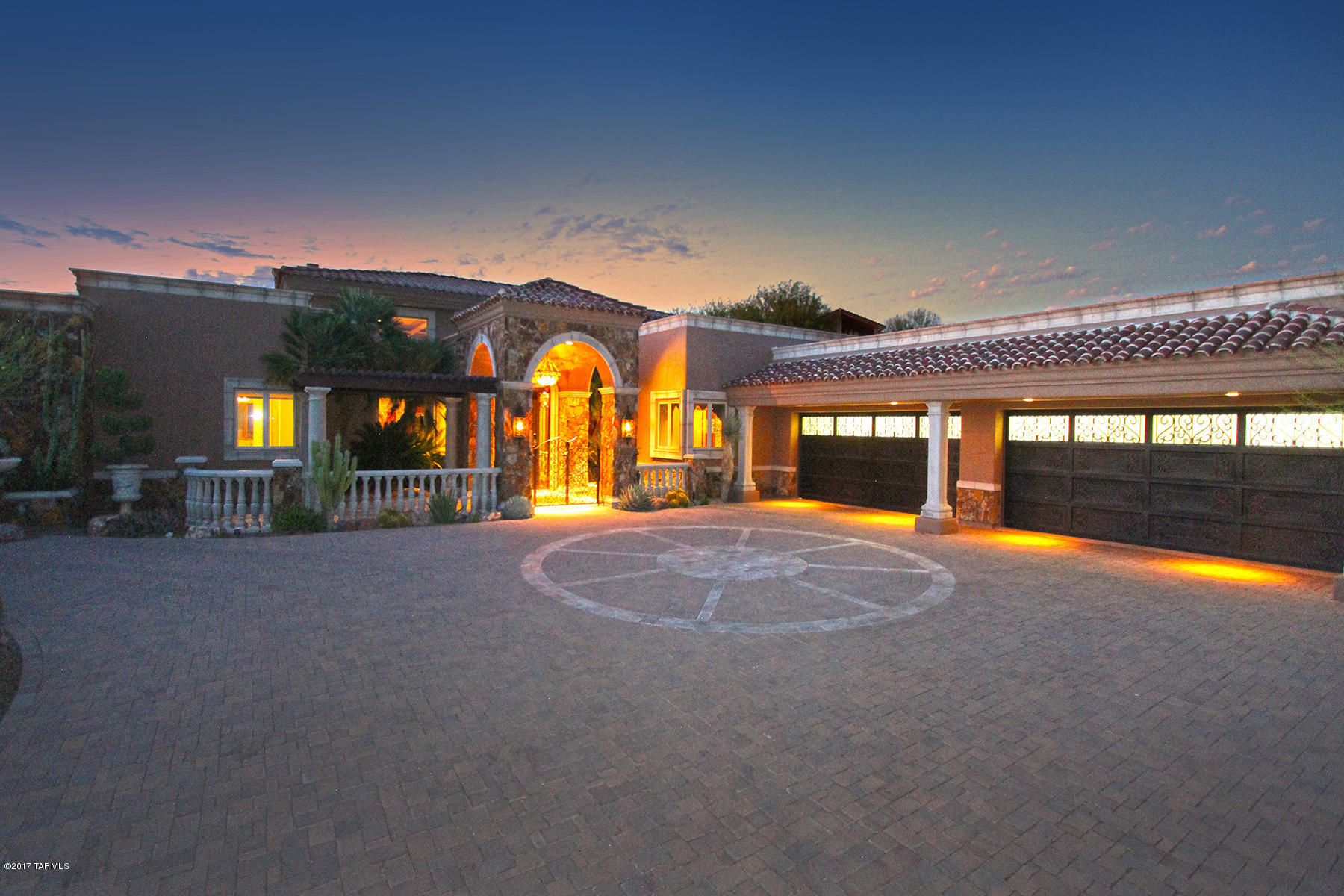 EXTENSIVELY REMODELED EXQUISITE TUSCAN Estate located in an upscale guard gated community. Majestic custom iron door and domed barrel foyer ceiling embellished w/Italian tile welcomes you. Spacious great room with 20' high wood ceilings, hand carved wood columns, travertine fireplace and custom built-ins. Chef's dream kitchen with beautiful custom cabinetry, granite counters, limestone sink, Wolf/Kitchen Aid appliances with custom Armoire for Sub-Zero. Custom wood & marble flooring throughout. Large family rm. Private master suite w/sitting rm and luxurious bathroom with steam shower. Resort living w/outdoor kitchen, pool, spa, loggia, fireplace, fire-pit, stone pavers, privacy and VIEWS! See floor plan, video, 3D video, custom list and Tucson Lifestyle article! Price reduced over $350,000 Approx. $1,000,000 spent on renovations!  Price reduced over $350,000!! There are too many custom feature to mention so PLEASE see the Custom Feature List and Tucson Lifestyle Article about the extensive renovations in the attached documents. Please also view the special video. The interactive full size floor plan can be found in the virtual tour link in photo tab. 

The rear yard also offers 5 different outdoor seating areas with 2 fireplaces. Views of the Tortolita mountains from private gated desert garden displaying rare desert flora. The Al Fresco kitchen has industrial 60" SS grill and a kitchen equipped with ice maker, refrigerator, sink, bar caddy, stove and warming drawers. 
. 
There is an additional room in 4 car garage planned for wine cellar.