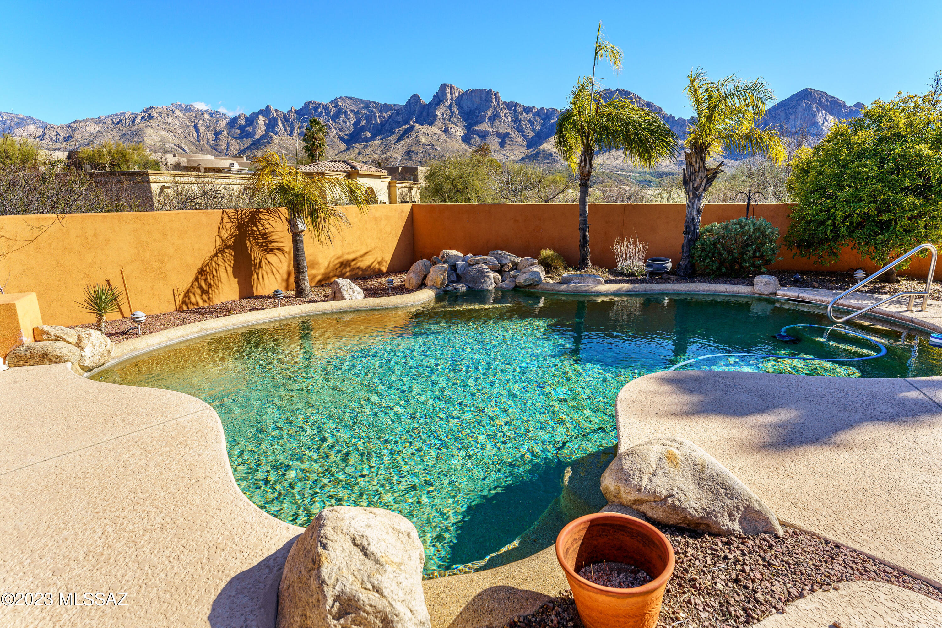 Make Your ''SOMEDAY'' Dreams Come True by snuggling into this choice setting with privacy, views, and space to breathe.  Located in a gated community in Oro Valley where space exists between homes and where the Catalinas and Pusch Ridge appear to be in your backyard.  (They sort of are!)  The patio, the pool, the bay windows with views from the dining area in the great room as well as from the primary bedroom, will make your heart smile.   It's easy to see that there are 4 bedrooms and the home is single story.  What's not easy to 'see' is what can  only be felt, by visiting this lovely home.  A place for new memories to be made.  With so many loving memories already within the walls of this beautiful home. . Spacious air conditioned garage with water softener enclosed in cabinet.  Some furniture for sale.  Estate sale planned for March 5th.  So, if you are interested don't wait to visit!