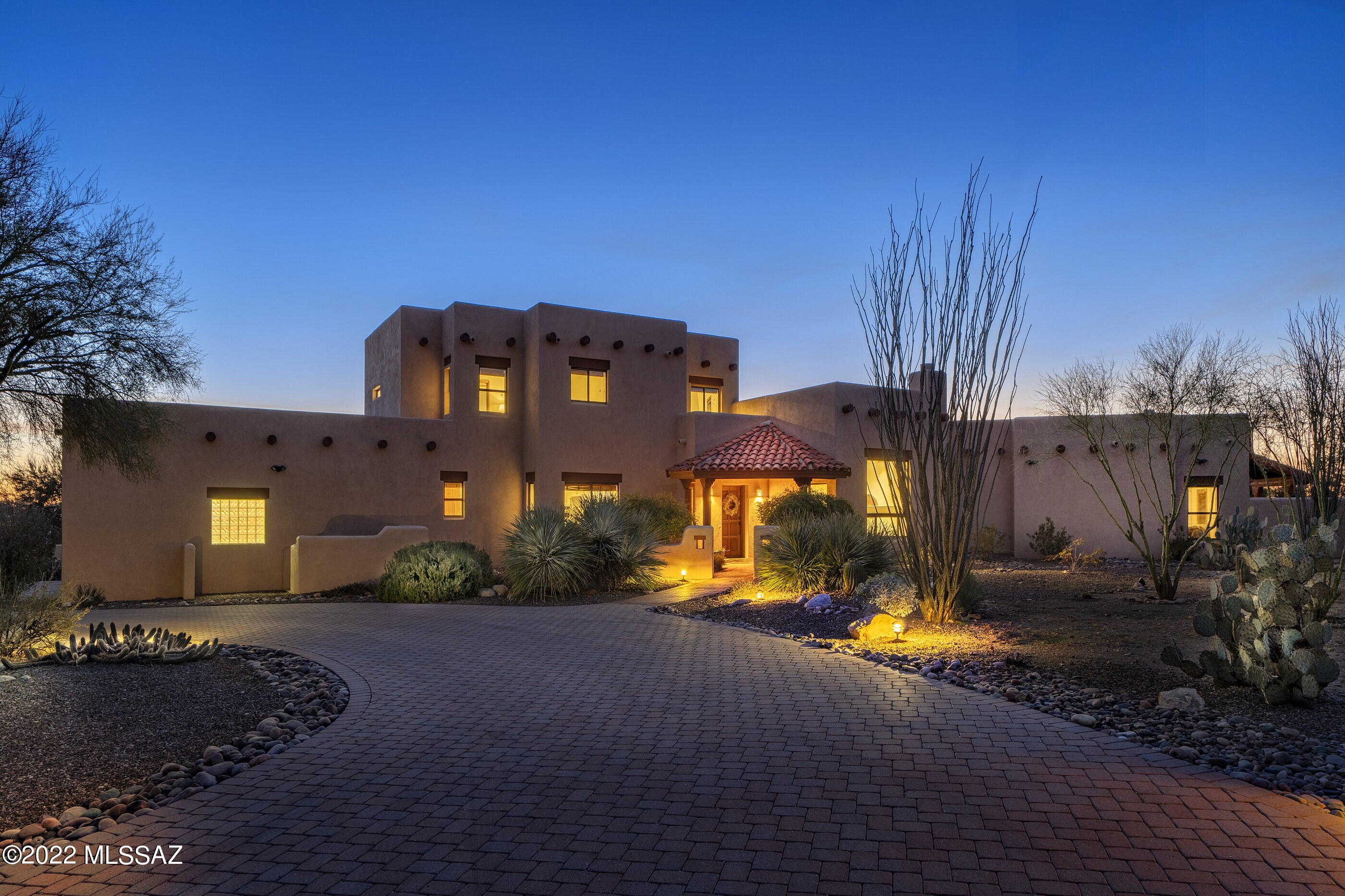 Wonderful Santa Fe on a spectacular, private view lot with mountain and sunset views and adjacent to the wash. This 4 BR/4BA gem features tongue and groove wood ceilings, beautiful vigas and corbels and views from every window,. Stunning newer eat in island kitchen w/SS appliances and quartz countertops which opens to the family room. Cozy living room with beehive fireplace and views of the Catalinas. Spacious Master Suite features fireplace, walk in closet, entrance to outside and is located downstairs. Step out to the large covered patio, perfect for entertaining and enjoy all the views. So much storage in this home, oversized 3 car garage with one bay designed for a RV. This gorgeous home has been meticulously maintained. Solar is seller owned.