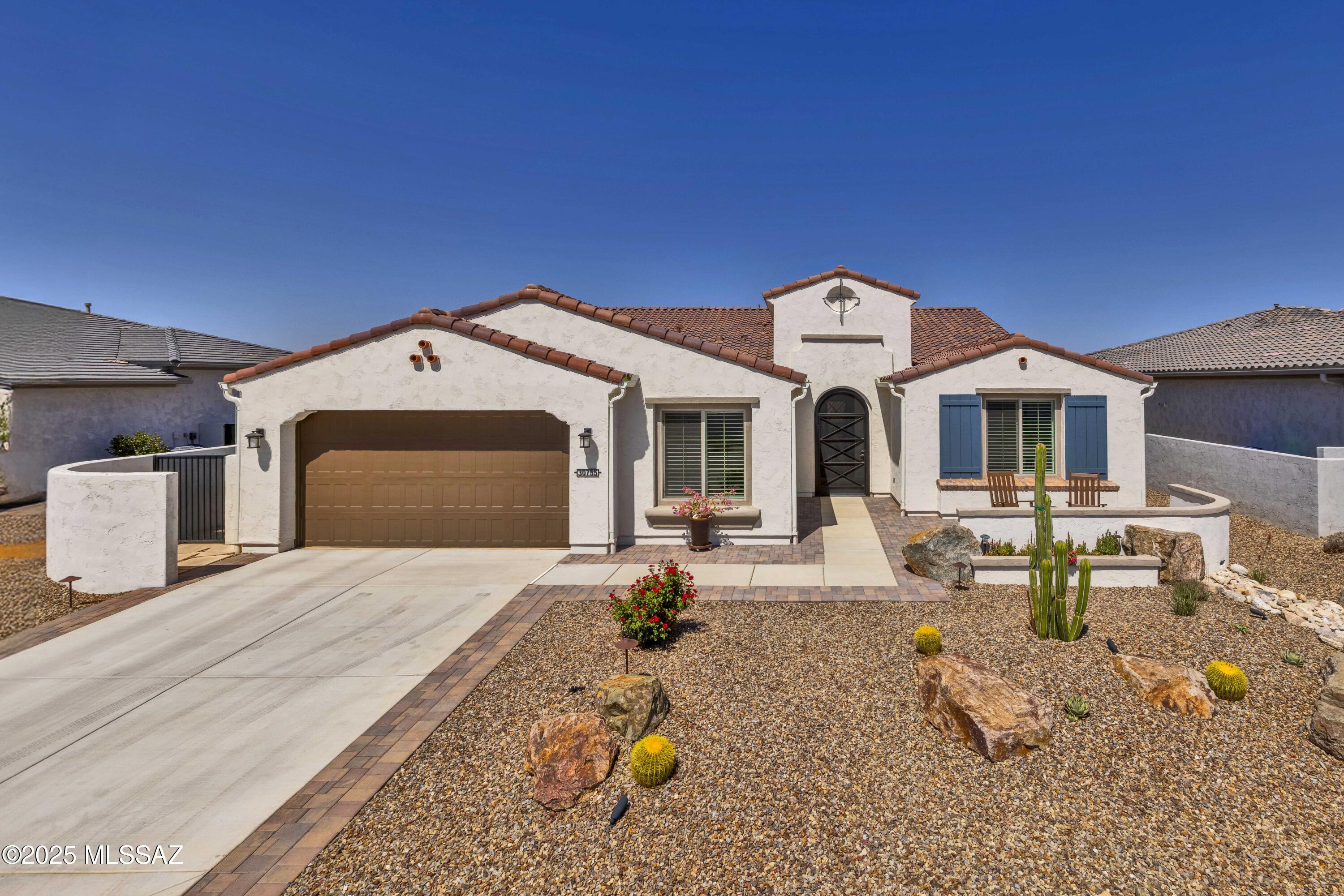 Vienta Model - Luxury and Functionality
Discover this custom Vienta model, a 2674 sq ft masterpiece blending elegance and practicality. Features include custom cabinetry, oversized quartz countertops, and a Great Room with built-ins. High ceilings, solid core doors, and refined trim add grandeur. Unique lighting fixtures enhance its timeless appeal.

Relax on the covered patio with a gas fireplace and stunning sunsets with mountain views to the left and right sides of yard. A versatile hobby room suits,crafts, games or an additional office space. The oversized garage accommodates 2 vehicles AND a golf cart!

Indulge in the stunning master bathroom featuring spa-like amenities and elegant finishes. The expansive walk-in closet offers ample storage and organization, making it a dream for any homeowner. Trust me when I tell you that this home shows even better in person. Come see for yourself! Schedule your tour today!
