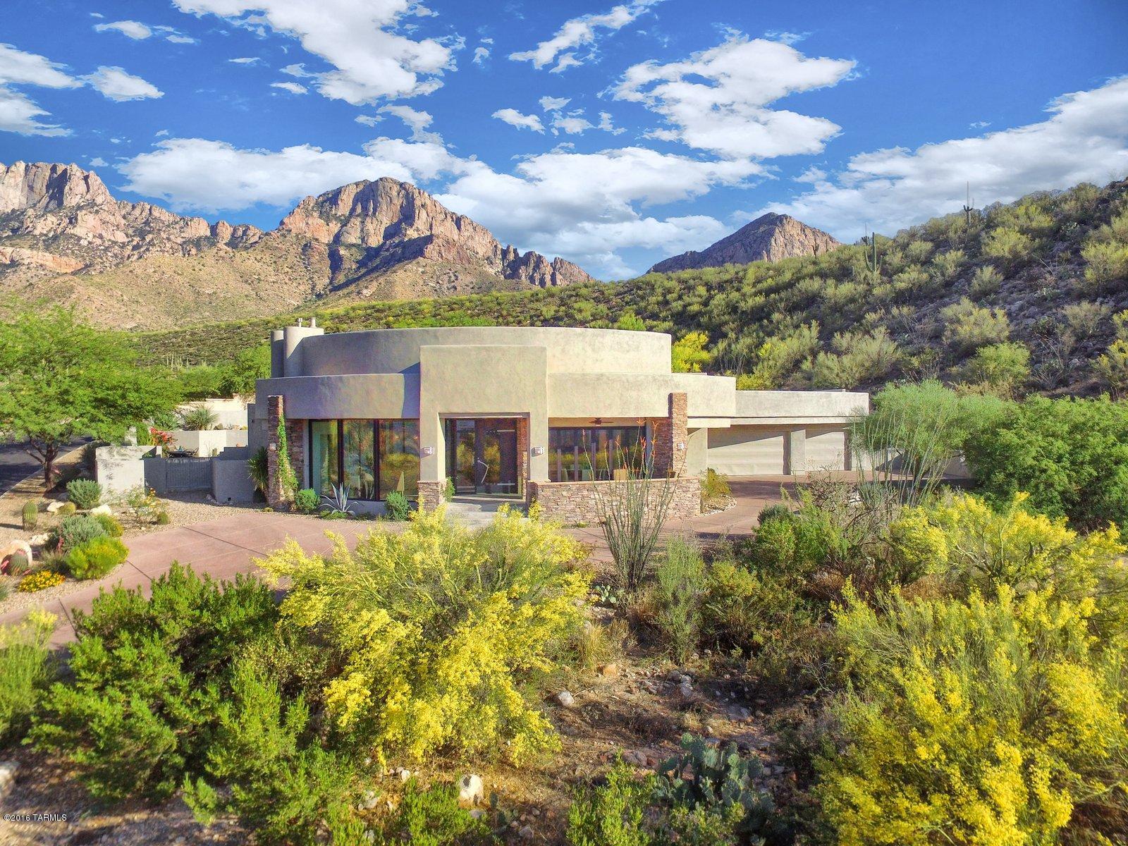 Truly a world class custom home in prestigious, guard gated La Reserve includes over 3 acres of untouched rock outcrops and saguaro cactus. Recently remodeled master suite with new freestanding tub and master sitting area. All low maintenance commercial grade aluminum frame windows and doors. Massive walls of windows open to unobstructed city and up-close mountain views, with remote operated electronic exterior shades and interior black-out covers. Sophisticated details include a massive & stunning custom front door, speakers throughout, spot lighting for artwork, breathtaking views from every window. Wolf cooking appliances, inc warming drawer in Dining area. All 3 HVAC systems include upgraded linear registers, electronic air filters, auto humidifiers and UV air sterilizers. Owner/Agents