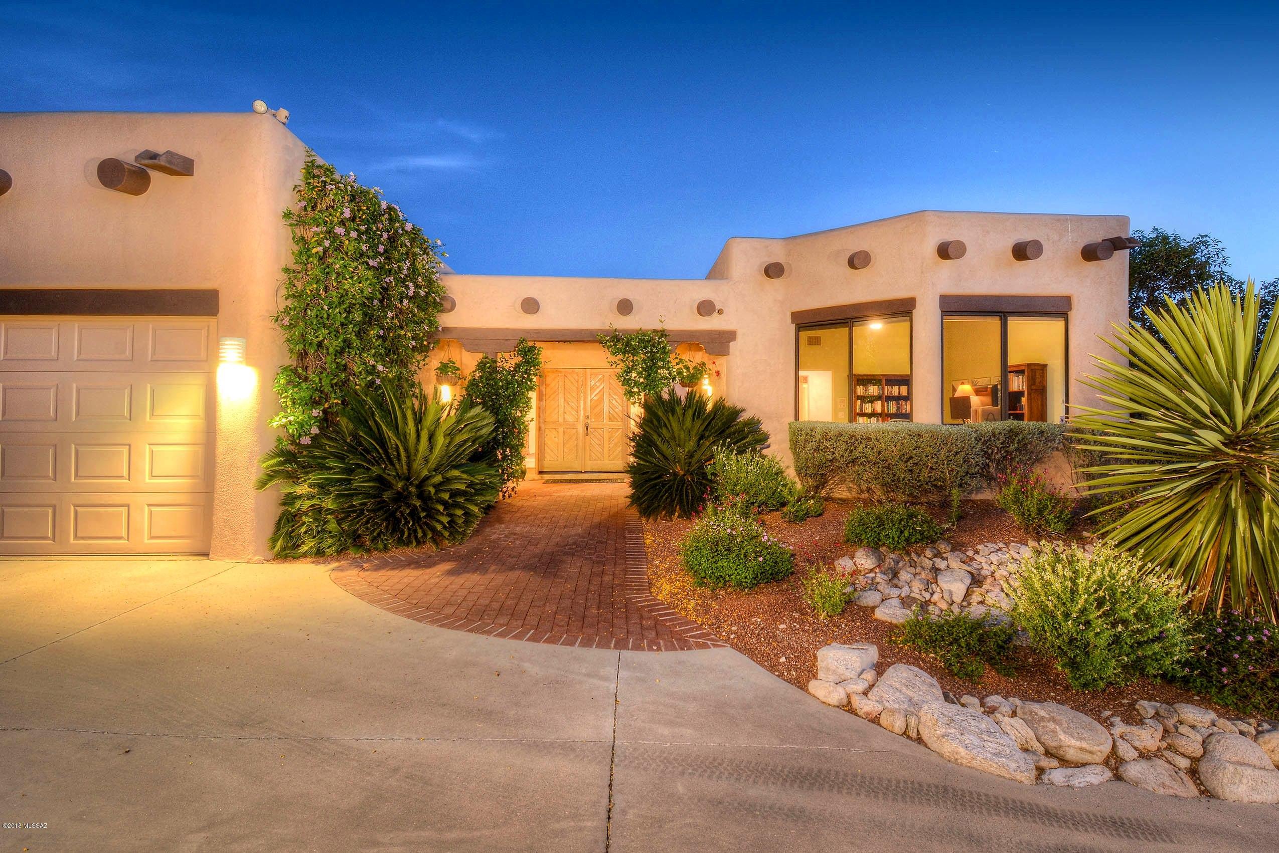 Come fall in Love with this Gorgeous Newly Remodeled Santa Fe Home with Stunning City Light Views nestled in the heart of the Catalina Foothills. The Fabulous spacious kitchen w/butted glass windows, rich wood cabs, solid granite counters, large island and breakfast nook will delight the chef in any family! The sky high wood beamed ceilings, huge picture windows, wonderful Family/Media rm w/custom built in cabs, separate family/living rm with fireplace and huge lush entertainers back yard provide Space, Comfort and Enjoyment for everyone. Generous master suite with beautifully renovated bath includes dual sinks, granite counters, garden tub and walk in shower. Topped off w/3 car garage, built-in vac & tons of storage all at the end of a secluded cul-de-sac lot waiting for the lucky Buyer!