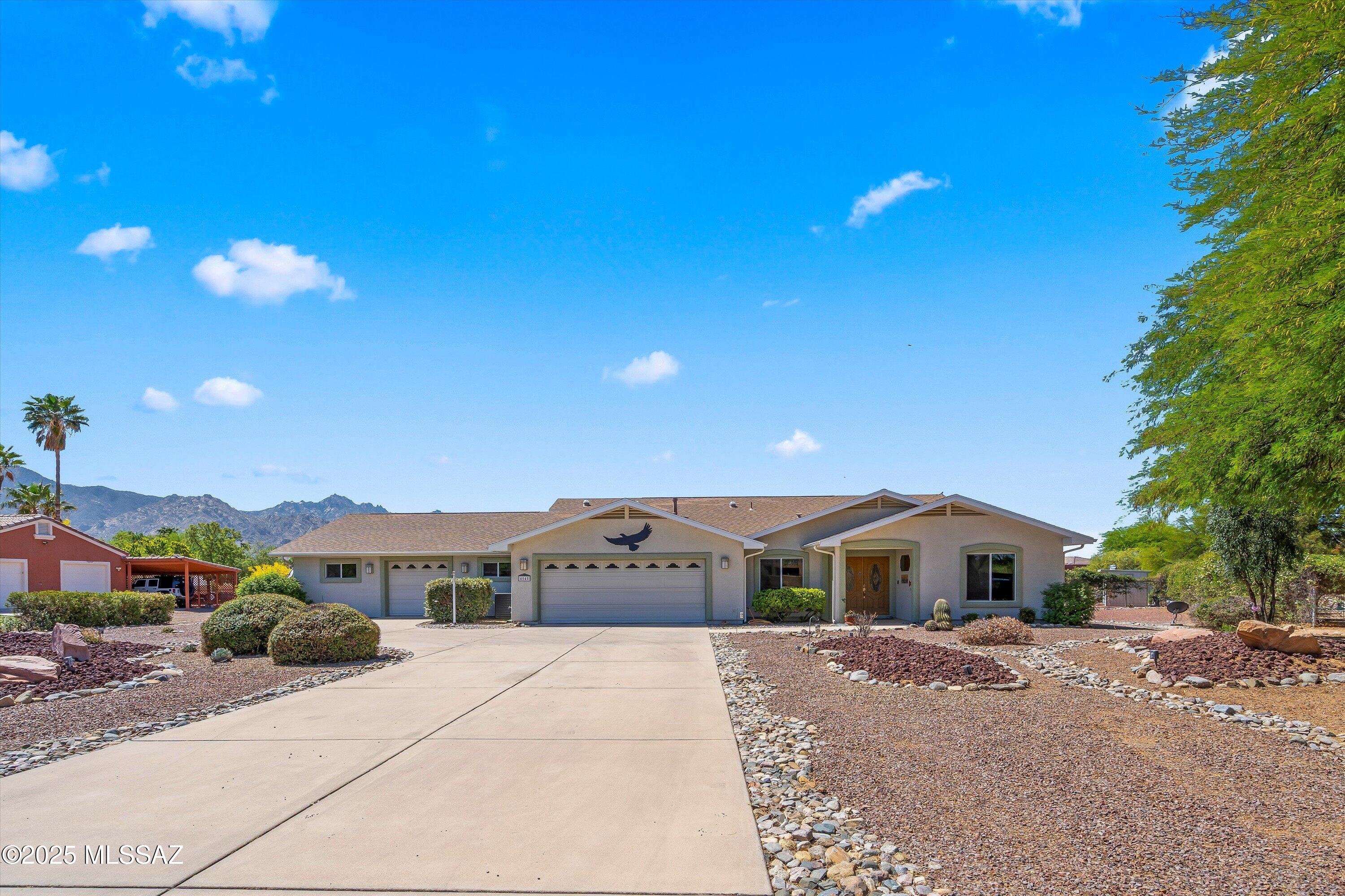 Gorgeous custom home with updated and upgraded systems. Here are some of the updates: tile flooring, interior and exterior paint,  elevated swim spa, appliances, water heater, water softener and so much more! There are two additional separate offices, owned solar, a 1000 sqft 220v workshop, and garage space for three cars.  Three year old AC units cool the home and workshop extremely well. Gorgeous custom cabinetry and built-ins provide tons of storage, and solar tubes and skylights provide natural light throughout the home. The beautiful outdoor landscaping capitalize on the AMAZING MOUNTAIN VIEWS!! All of this with no HOA! Come see your beautiful retreat today.