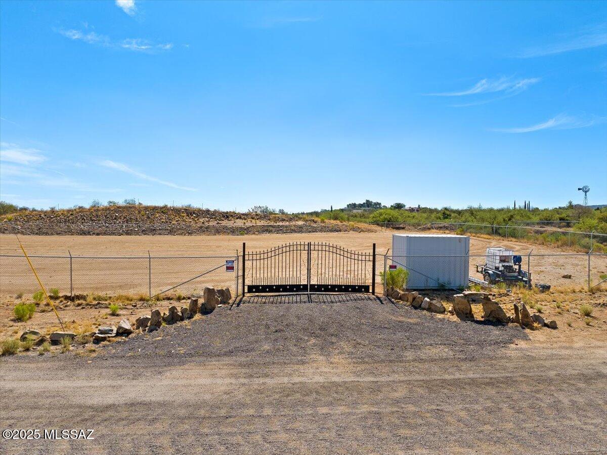 This versatile 2.16-acre commercial parcel offers a strategic location just off Highway 77 and American Avenue in the growing community of Oracle, Arizona. With easy access to major transportation routes and just 20 minutes to Oro Valley and Tucson, this property is ideally positioned for a wide range of business opportunities! The lot is completely enclosed by a heavy-duty chain link fence topped with security wire, ensuring maximum perimeter protection for equipment, vehicles, or future structures. The parcel has already been professionally graded and includes erosion control measures to maintain lot integrity during monsoon season and beyond. With utilities located close by and zoned CB2 (Commercial Business), this level, dividable property is perfect for storage facilities, contractor yards, or other commercial uses. Whether you're an investor, developer, or business owner looking for your next venture, this secure and shovel-ready lot is a standout opportunity in a cooler, scenic high-desert setting.