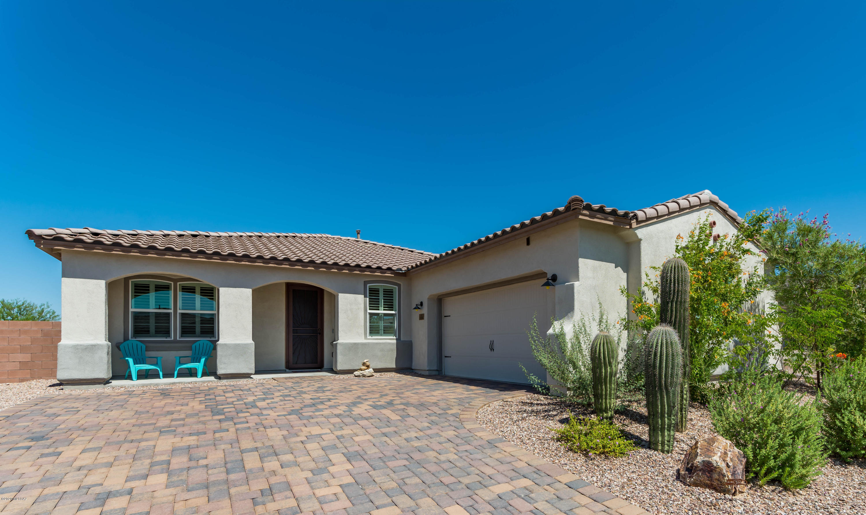 Stunningly beautiful larger pool & spa w/great Tortolita Mountain views. Firepit sitting area, full grassy area with specific sprinkler system on side of home. Great for pets/kids. Backs to nature with abundant view fencing. One side of home abuts natural desert habitat - no homes. This homesite has much privacy and is on a larger lot.  Lookout Model with the option of 3 full bedrooms. Gorgeous gourmet kitchen with expansive breakfast bar island.  ALL tile flooring throughout. Plantation shutters.  Expansive brick pavers front and rear.  Pool/spa are saltwater and have 2 in-pool umbrellas. This is a great location - great sized lot - full entertaining rear yard - and boasts great privacy. Located on a cul-de-sac street - little traffic. Call to set up future showing.  Quick close possible.