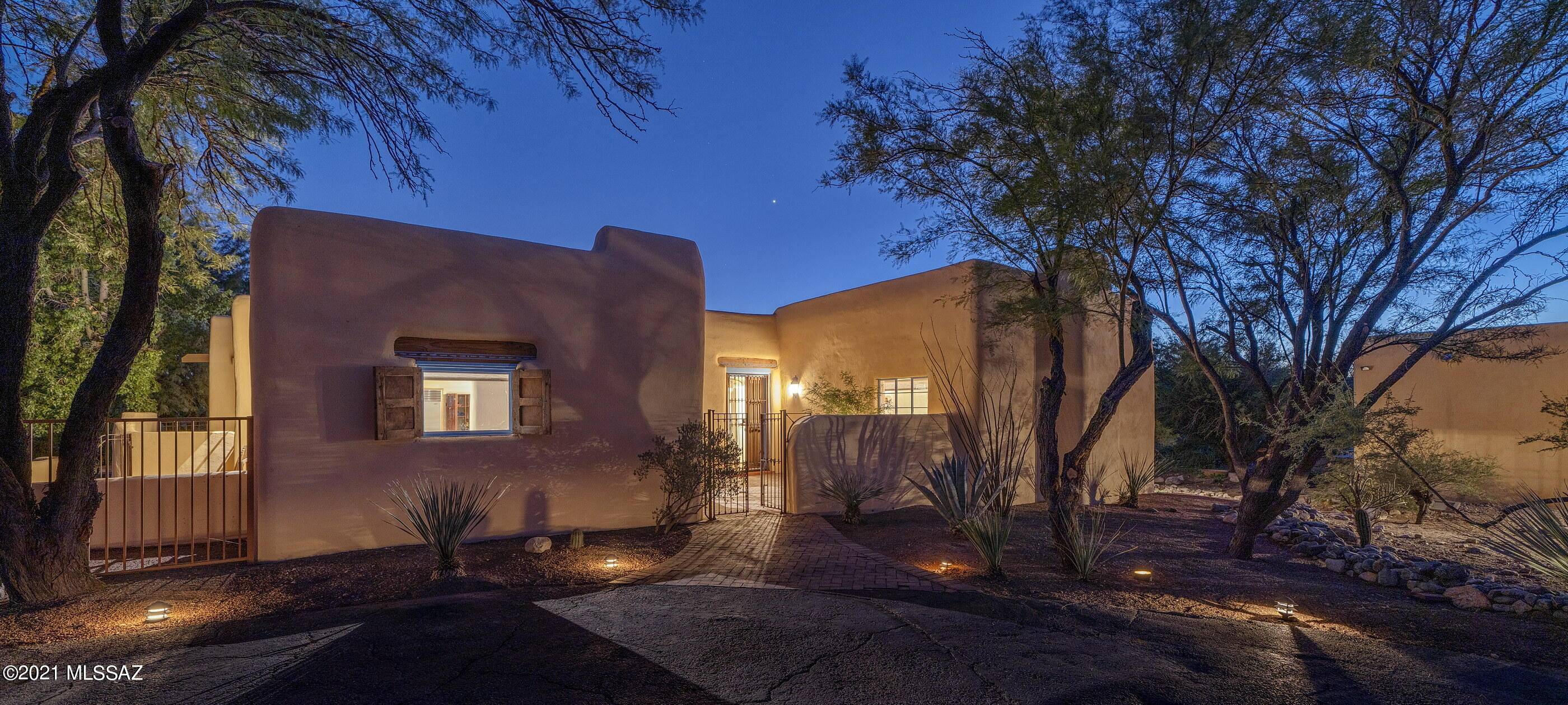 An authentic ''Charles DeConcini'' Mud Adobe, tucked away within the Casas Adobes community, one of Tucson's most sought after neighborhoods, meticulously hand-built, using craftsman techniques and materials, with all the modern conveniences of today. Enter through a private courtyard into a high design interior space that complements and reflects this regional vernacular, utilizing a delicate balance of tones, textures, and finishes, providing the ideal backdrop for the individual design sensibility. Constructed of stabilized Mud Adobe, this mass wall system offers substance, as well as thermal properties, perfectly suited for our desert climate. 3,634 square feet of interior living space consisting of 3 Bedrooms & 2 Bathrooms consolidated within the main residence, with an attached... 2 car garage. The property also features a detached studio guest house/flex space, that is perfectly utilized as a tranquil retreat, or cozy guest living quarters, as well as an additional oversized 3+ car garage, situated as an ancillary structure to the property. 

Upon entry one is greeted with archetypal wood beamed saguaro ribbed inset ceilings stretching the length of the Zaguan and proportions that provide volume of scale and space, while also retaining a welcoming sense of intimacy. 

Sited on an ideal North/South axis and beyond the home's traditional Territorial reveal, one is greeted with soothing tones and textures, complimented by the exquisite attention to detail of this designer home, providing a visual and tactile experience. Classic red stained concrete floors juxtaposed against soft plastered walls, enhance the curvatures of the natural materials from which this home was constructed. 

The kitchen's disciplined design features are set off by the Viking and Subzero stainless steel professional series appliances, with bleached wood cabinetry, wrapped in white countertops and a traditional Talavera tile backsplash, overlooking the informal living spaces and dining room. A sumptuous owner's suite is privately sequestered on the East wing of the residence and is ideal for those in search of a split bedroom floor plan. A series of exterior windows open onto the grounds, filling the room with soft, natural light, providing a reintroduction to the home's effortless blend of laissez-faire. 

Maximizing the dramatic relationship between interior and exterior spaces is achieved through careful design and placement of the structure with connectivity to the surrounding landscape. Layers of covered patios are perfectly suited to enjoy year round, with views stretching out over the native vegetation, causing an explosion of color, light and shadow, creating the perfect framework for the sun drenched pool, acting as the centerpiece of this classic courtyard vernacular home.