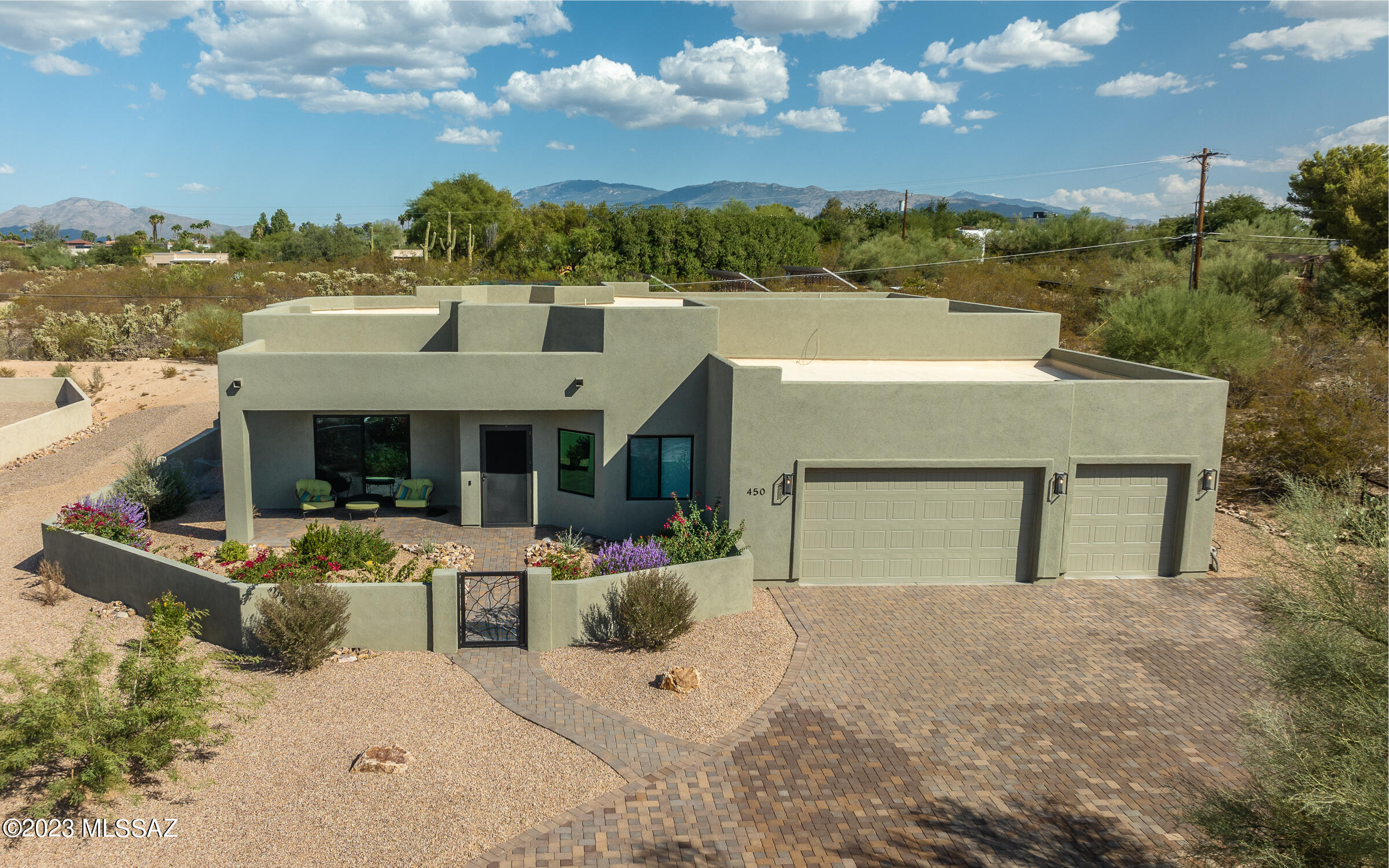 Luxurious gated Central enclave - this home combines the ambiance of luxury, the convenience of location and the ease of being less than two years old!  Abundant natural light was artfully created by the architect, sharing views of the mountains, sunset and lush desert trees.  The floorplan flows easily from foyer to dining to great room and boasts a chef's kitchen with double oven, induction cooktop, tons of prep space and storage.  Add an oversized three car garage, quiet location off the road with one other gated home, spacious rear yard with privacy fence and tons of room for a pool, garden and more and then comfortably accessible with no steps and wide hallways - a serene yet comfortable environment.  With no HOA, room to add a guest house or workshop too