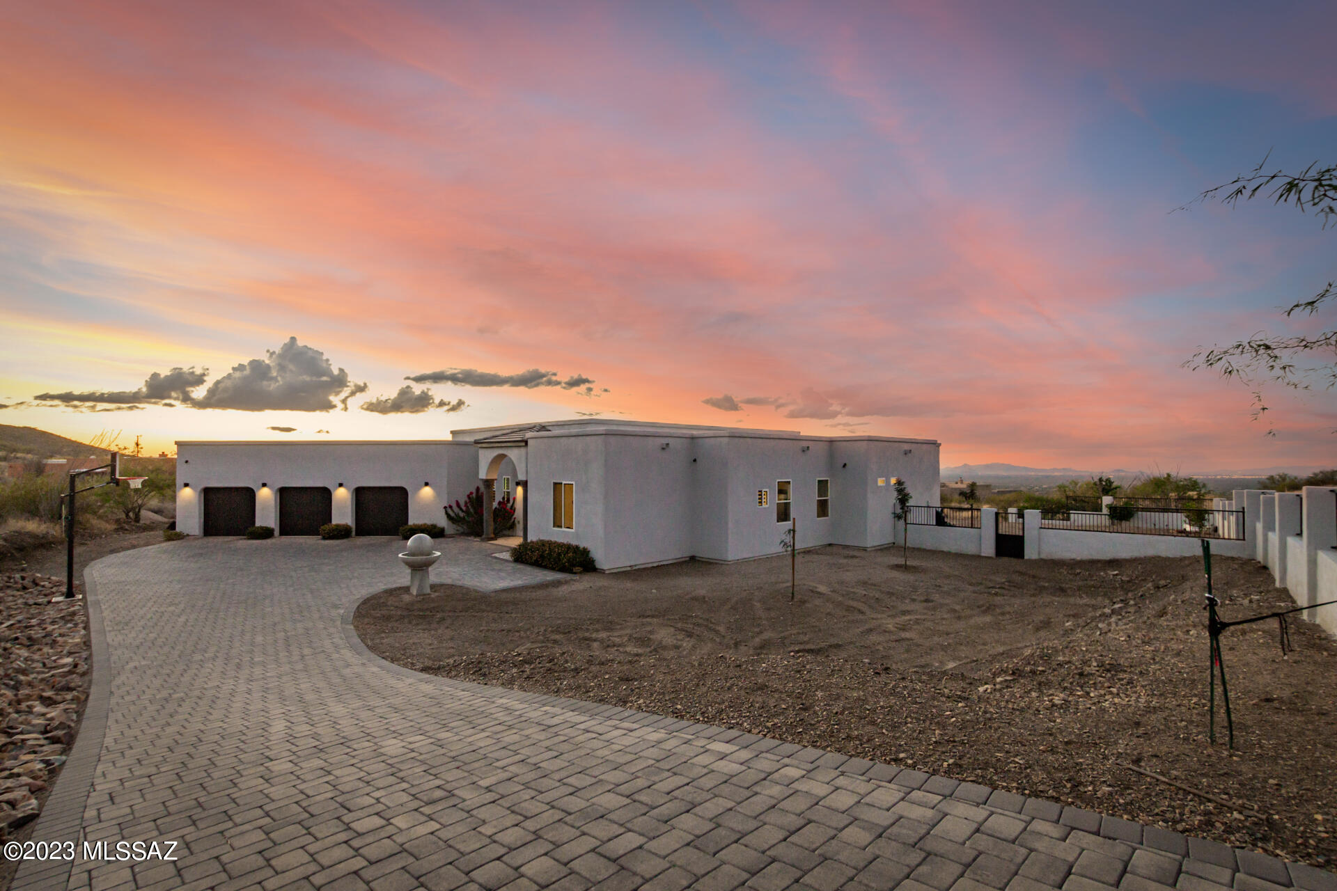Nestled on a sprawling 4-acre expanse, this impeccable single-level abode boasts uninterrupted panoramic views of majestic mountains! Every inch of this fully-fenced estate speaks of refinement, starting w/the grand front yard & a 3-car garage, complemented by an extended paver driveway. Custom double doors open to a sophisticated foyer, amplified by tall ceilings, polished concrete floors, & graceful archways that hint at the luxury within. The sizable living room, flooded w/natural light, promises warmth & comfort w/its contemporary gas fireplace, pre-wired surround sound, & multi-sliders to the back patio. Meticulous attention to detail is presented in the chef's kitchen, fully equipped w/an electric cooktop, double wall ovens, & granite counters. Click ''MORE'' for more details Artfully designed light fixtures, striking tile backsplash, a wine rack, & an island w/a breakfast bar elevate the space further. A plethora of white cabinetry w/crown molding & a walk-in pantry ensures ample storage space. The primary suite is a haven of relaxation, offering captivating outdoor views. A cozy sitting nook framed by a picturesque bay window, & a pristine ensuite w/dual sinks, a step-in shower, & a walk-in closet make it the epitome of comfort. The expansive backyard promises endless moments of leisure! Whether it's unwinding under the covered patio, swimming in the crystal blue pool, or simply soaking in the unparalleled mountain & desert vistas, this home truly captures the essence of luxurious living. This gem won't disappoint! Milgard windows, Build in speakers located in living room, kitchen and patio. Gas is available at lot line