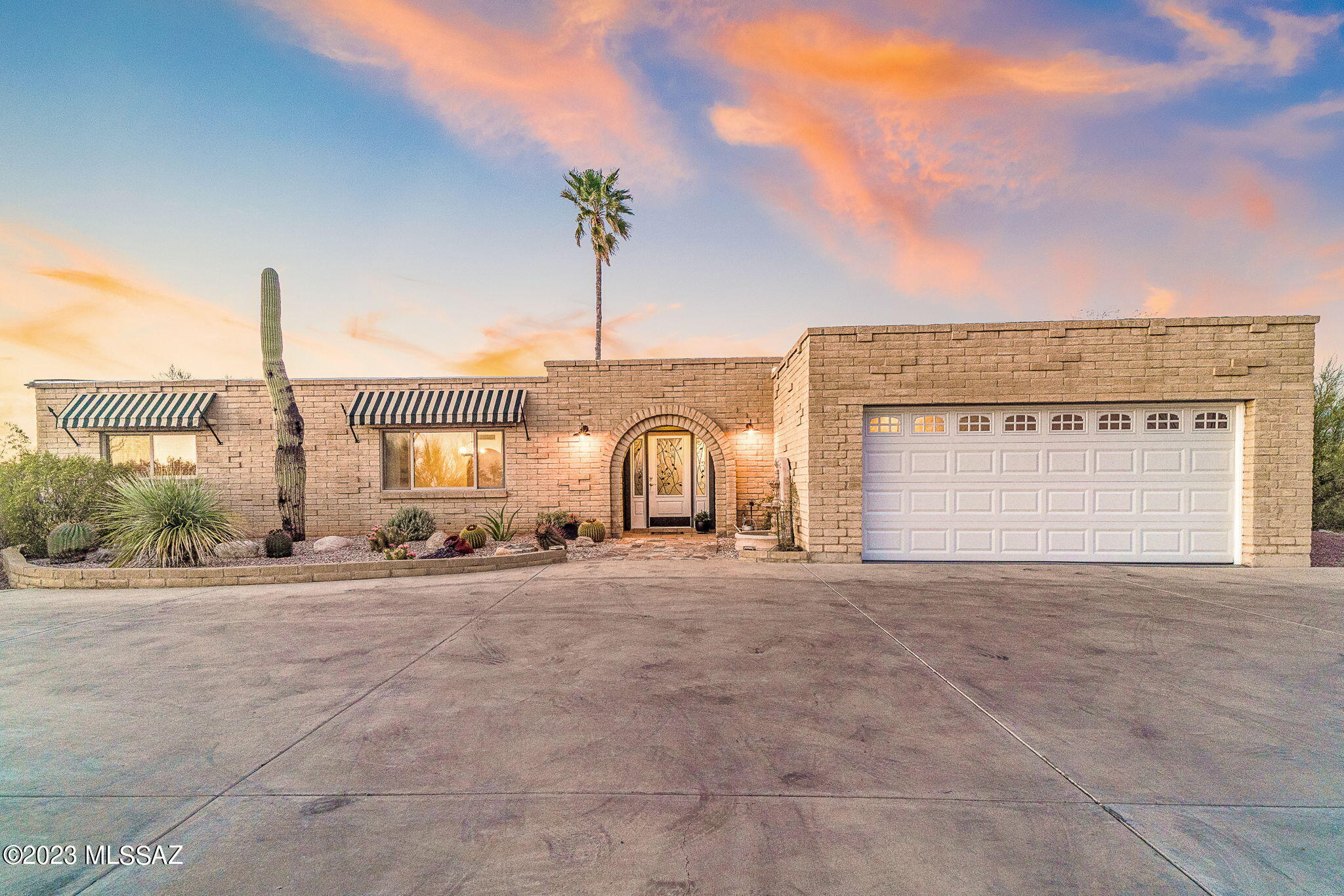Stunning 360-degree mountain and city views abound from every angle of this hilltop Foothills home.  Exceptional privacy from a secluded cul-de-sac lot and unrivaled views set this home apart.  Every space has been thoughtfully planned out to capitalize on the tranquility wrapped around the home.  Climb up the custom designed spiral staircase to take full advantage of the dramatic mountain and city views from your rooftop deck.  Views of the Catalina, Rincon, Santa Rita, and Tucson Mountain Ranges in addition to downtown Tucson, U of A stadium, A Mountain.  Everything that makes Tucson unique and special surrounds you.  Enjoy the sunset and watch as the city lights twinkle to life.  Take a stroll down to your peaceful chiminea overlooking the wash for a smores party.  The sparkling pool and nearly new hot tub are perfectly located to maximize your enjoyment of the Catalina mountain views, creating a captivating oasis.  Grapefruit, plum, tangerine, pomegranate, peach and Cara Cara orange trees surround the meticulously maintained north-facing bacyard.  Step inside to discover a lovingly cared for home.  Large windows, skylights and sliding glass doors allow plenty of natural light throughout the home and allow the full benefit of the panoramic mountain views.  The kitchen is in the heart of the home and has been recently updated with granite countertops, pine cabinetry featuring large pull-out drawers. LG refrigerator and range, featuring "knock-on" technology, are brand new.  A perfectly placed full bathroom with custom stain-glass window off the family room allows visitors to the pool to step right inside from the pool patio to the bathroom.  The primary wing features a dreamy 450 square foot master bathroom.  Extra large soaking garden tub, huge steam shower, dual vanities, water closet with Kohler bidet and toilet.  A large window featuring Rincon and Catalina Mountain views and direct access to the spiral staircase leading to the rooftop deck are all highlights of this space.  HVAC with Air Ionizer, Water Heater, Roof, Pool Equipment and Pool Heater, Irrigation system all recently replaced.  Please see Features Sheet for a complete list of upgrades.  Low HOA, close proximity to 'The Loop', an interconnected system of more than 120 miles of paved pathways and bike lanes, and all of the shopping and dining you desire from your private oasis in the center of town.  Come see this one of a kind home today!