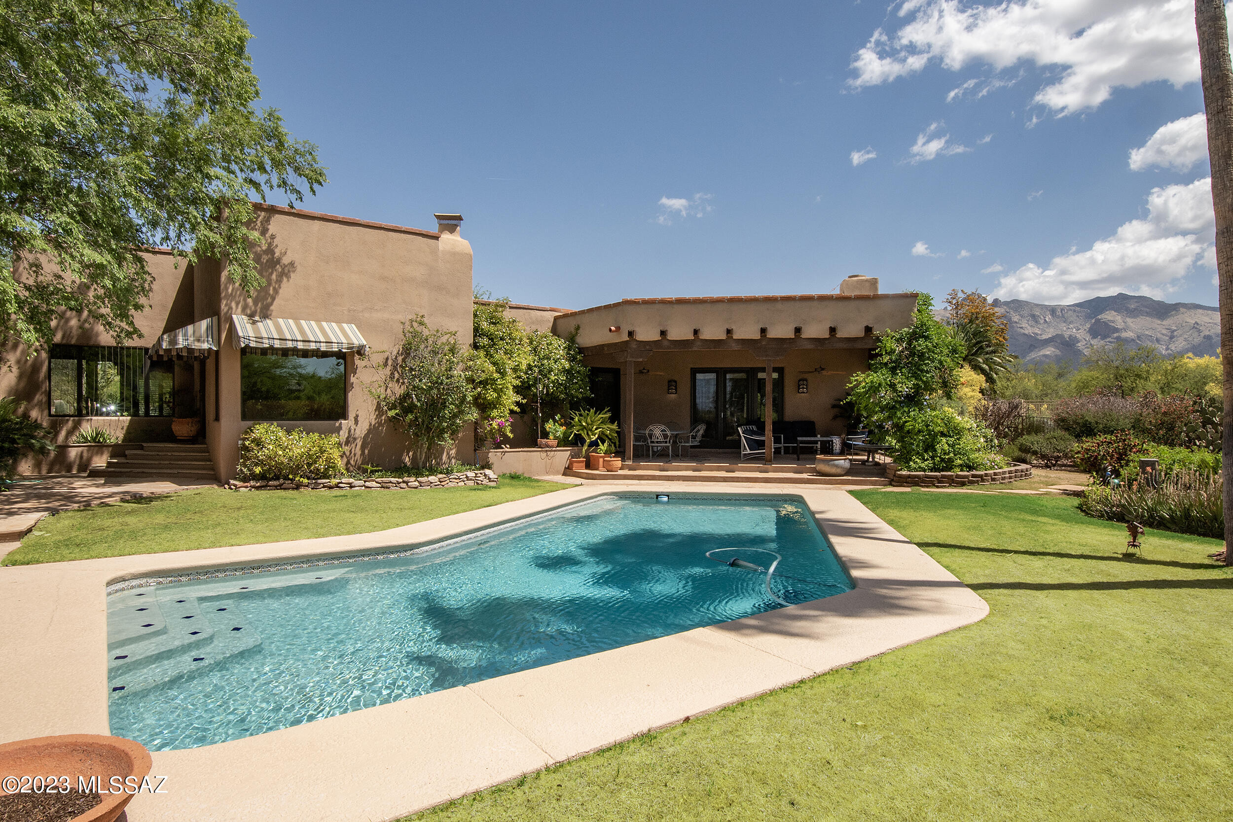 This one has it all! Space for everyone & everyone has a space! Warmth & charm define one of Shadow Hills' original residences in a neighborhood where families flocked when Catalina Foothills schools were built.  Located on a quiet street in the heart of this sought-after neighborhood. Beautifully constructed with Pella windows thru out, beamed ceilings, multiple fireplaces & Mexican tile floors.  A formal living and dining room, PLUS a family room PLUS a huge entertainment room. Beautiful backyard with pool & mountain view accessed thru French doors from every area. Island kitchen with breakfast area is open to living spaces. Fabulous guest suite on one end provides separation. Three-car garage with loads of storage.

Adjacent .7 ac  lot available - $1.625M for house and add'nl lot