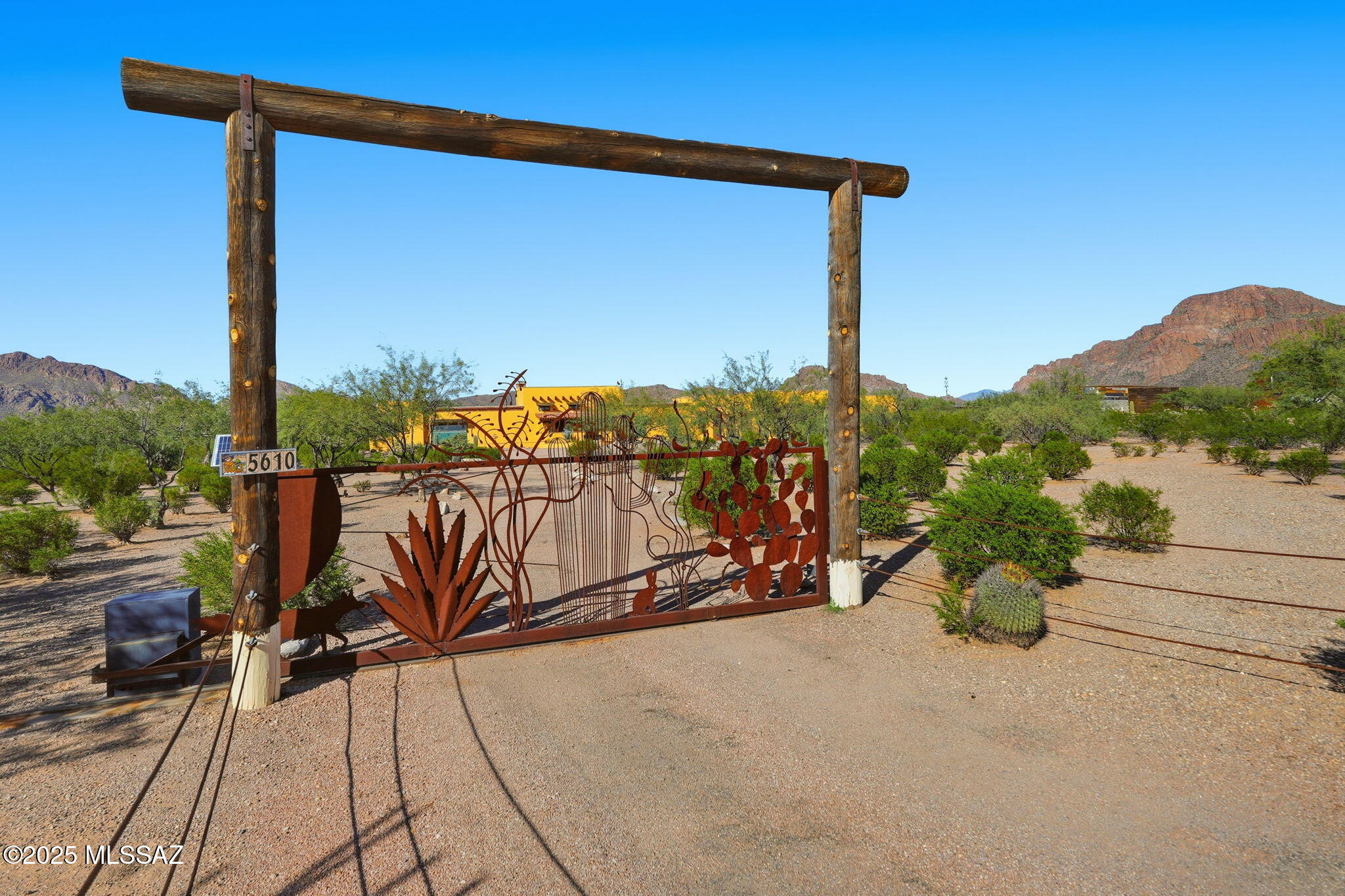 Stunning 2,600 sq. ft. desert ranch featuring 3 beds, 2.5 baths, terrazzo style floors, mosaic tile floor art, and dual-paned windows. Custom kitchen and spacious owner's suite with walk-in closet, separate shower, and soaking tub. Detached 3-car garage with 4th bay/workshop, ideal for a studio or tack room. Enjoy a jetted spa, custom outdoor lighting, solar, greenhouse, tortoise pen, and RV cover with electric. Easy access via steps or ramp. Zoned suburban ranch for horses and animals. Breathtaking views and low-maintenance desert landscaping complete this exceptional property.