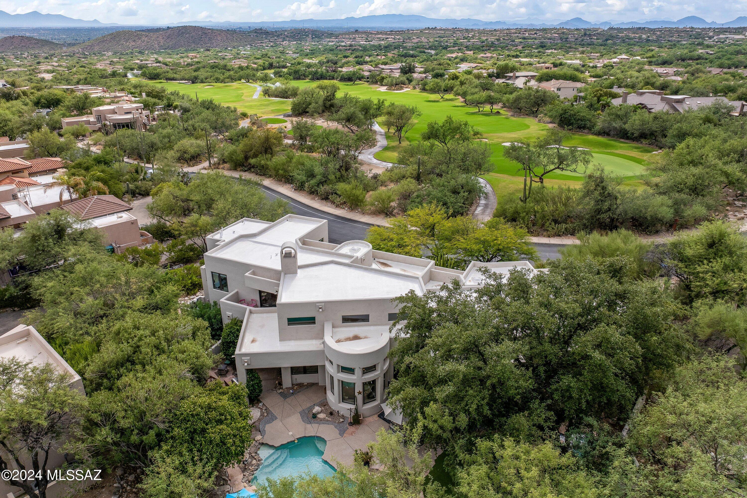 Experience the beauty and comfort of Ventana Canyon living!

This meticulously maintained custom residence features 4 bedrooms and 4 bathrooms, with beautifully appointed spaces, including well-maintained bathrooms, elegant travertine flooring, and fresh custom paint throughout.

The modern kitchen is a chef's paradise, boasting exquisite granite countertops, a unique subway tile backsplash, an expansive island, stainless steel Bosch appliances, custom cabinetry, and chic lighting—seamlessly integrated into the inviting family room, which includes a striking stacked stone fireplace.

The living room/lounge  enhances the home with custom cabinetry, a granite-topped bar, a beverage refrigerator and an ice maker, making it perfect for entertaining guests. The first-floor master suite offers a private office, French doors leading to the outdoor space, and a luxurious bathroom equipped with a freestanding copper tub, custom cabinets, granite surfaces, and a glass rain shower.

Upstairs, you'll discover two guest rooms with breathtaking city and mountain views, a contemporary Jack and Jill bathroom, a cozy loft, and two balconies.

Additional highlights include Pella windows and doors with built-in blinds, a three-car garage with new doors, and a secluded backyard featuring synthetic grass, a BBQ area, and newly renovated Pebble Tec in the pool and spa, complete with a colorful lighting system. Recent upgrades include a new roof installed in 2024, a Culligan system, New Exterior paint, Sonos sound system, all-new HVAC systems, new carpet, tankless water heater, and an EV charger, along with a new irrigation system.

This exquisite home seamlessly combines luxury and functionality, making it perfect for both relaxation and entertaining. Don't miss your chance to own a stunning property in one of the most desirable neighborhoods.