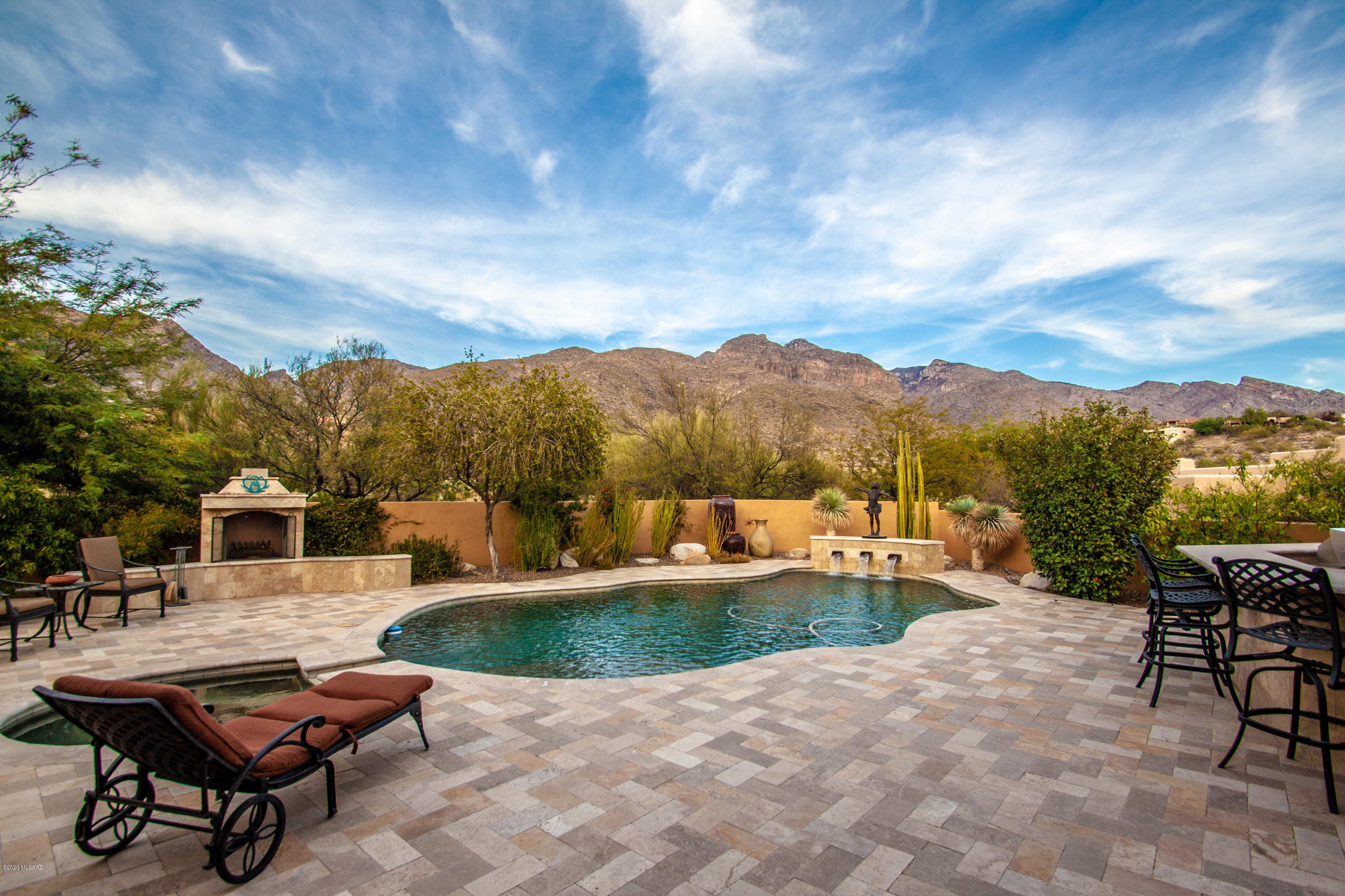 Spectacular 5 BR Hm in Pima Canyon Estates w/ Breathtaking Mountain Views from almost every room in the home, & especially from the Patio/Pool/Spa area. Extensive Travertine Deck around Pool/Spa, Water Feature, Outdoor FP, Lg Rear Patio, & around Built-in BBQ & Bar. You will be in awe when you walk into the Kitchen & see the Picturesque Mt Views! Split BR Plan w/ Master BR & Office/BR#2 on one side of the home, BR's #3 & #4 w/ Bath on the other side, & BR #5 & Bath in a private central area of the hm; Ceramic Tile & Engineered Wooden Flooring; Cozy Family Rm off Kitchen w/ Wooden Ceiling & Wooden Shutters. 2 Newer HVAC systems-2018; Newer Wood Casement Windows & 3 Rear Doors; Newer Interior & Exterior Paint-2019; Roof Resealed-2019; TV system on patio; New Epoxy finish-3 Car Garage & MORE
