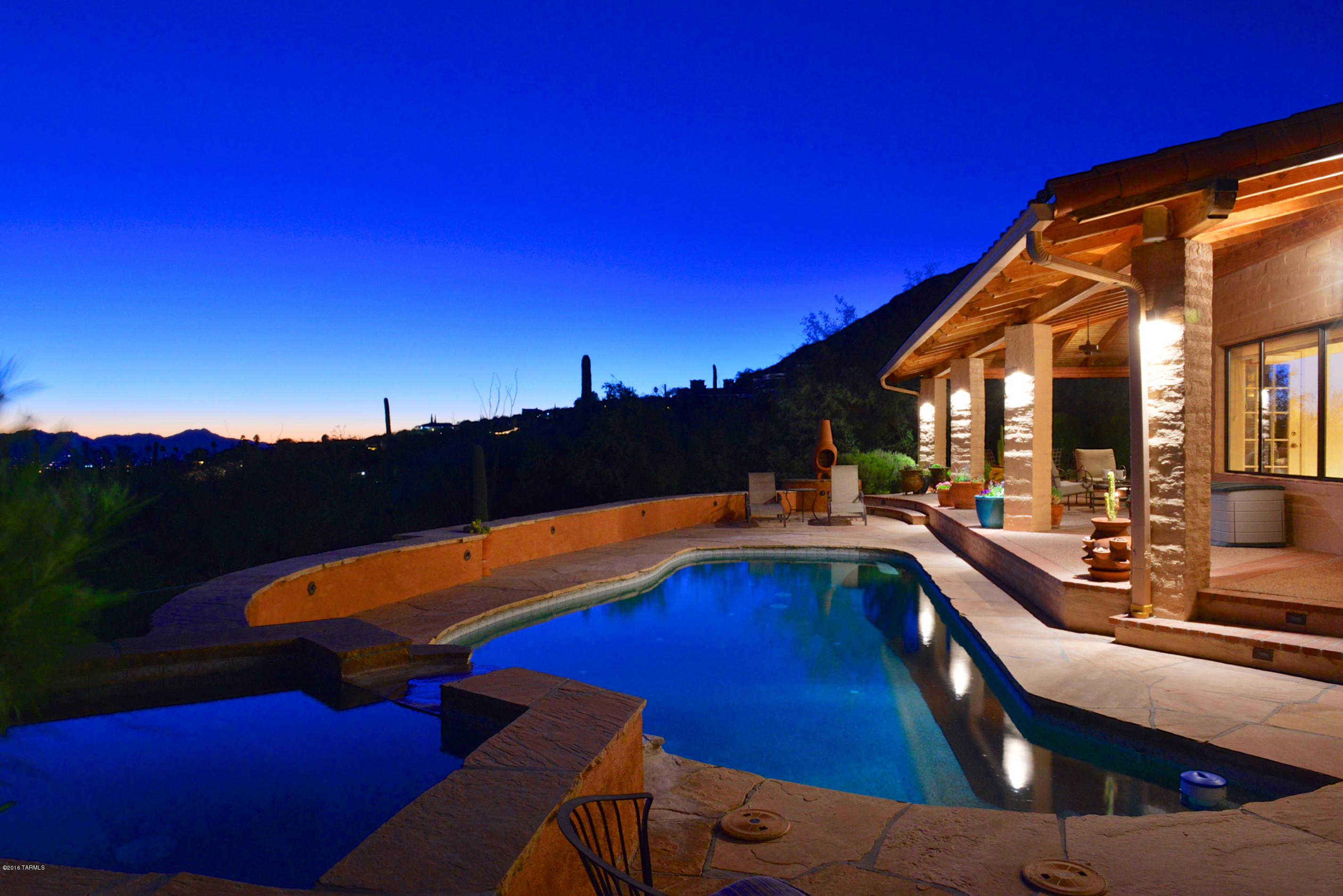REDUCED $94,000!  This finely crafted home sits on one of the premier lots in the Foothills.  The residence is oriented on the site to maximize privacy, magnificent vistas, and capture the beauty of the natural desert surroundings and vegetation.  Completely remodeled throughout to meet current tastes and high standards.  A majestic wrap-around covered patio with tile roof and exposed beams provides an additional 1200 sqft of outdoor living space, plus an outdoor cooking area with fireplace and seating area.  The grounds feature a distinctive boulder rock wall, a large assortment of native and exotic cactus planting, and plenty of parking on the level driveway.  This home is a truly unique opportunity for a buyer with an eye for quality and appreciation for the Southern Arizona lifestyle