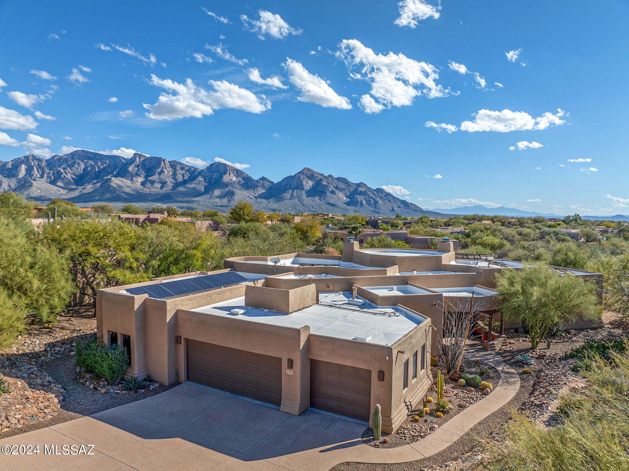 Serene and Picturesque setting located in Oro Valley. Sweeping Mountain Views. 3 Bdrms + Den. Vacation at home, resort-like backyard with salt water heated pool,  raised spa with waterfall, Kiva fireplace, expansive rear patio framing Pusch Ridge with beamed ceiling.  Gourmet kitchen with cozy nook, newer appliances, subzero fridge, dual islands, granite counters, breakfast bar. Kitchen opens to  Great Room. Great Room features custom fireplace.  Formal dining room with coffered ceiling. Elegant formal living room featuring a custom fireplace & grand sweeping viga beamed ceilings with a wall of windows framing the mountains. Primary suite includes luxury bath with jetted tub, tiled walk-in shower. Secondary bedrooms with jack/jill bathroom.  Private office/den. Owned Solar. EV Ready