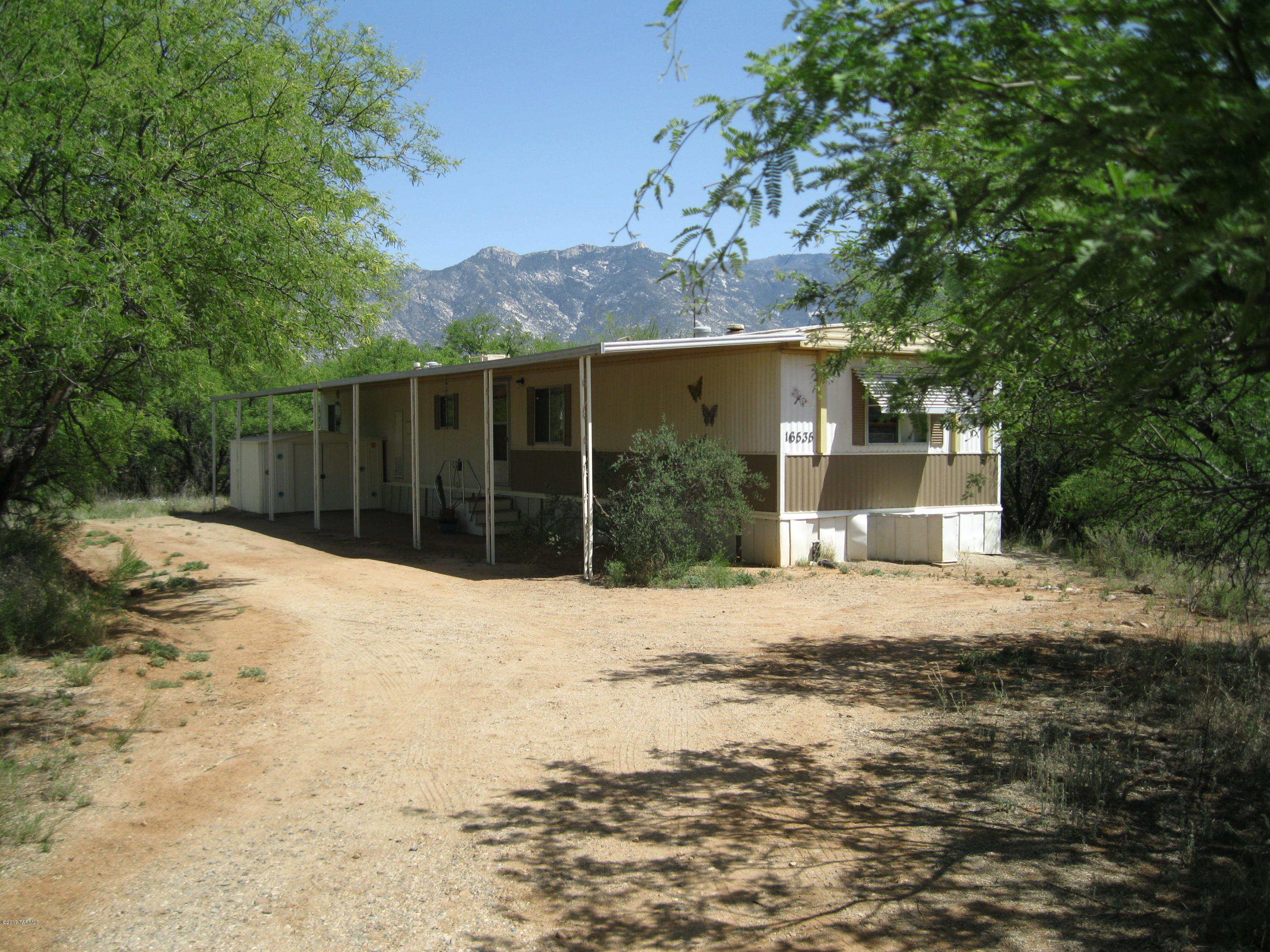 Very private, quiet and nestled in the Mesquites. Split bedroom floor plan with BR and full bath at each end. Open kitchen and living area with new curtains, fresh paint, all new flooring and brand new A/C (to be installed upon acceptable offer). 10X10 outdoor storage, storm windows & large covered patio.Owner  may carry with approved terms and conditions with $25K down, 4% interest, 10 year amortization