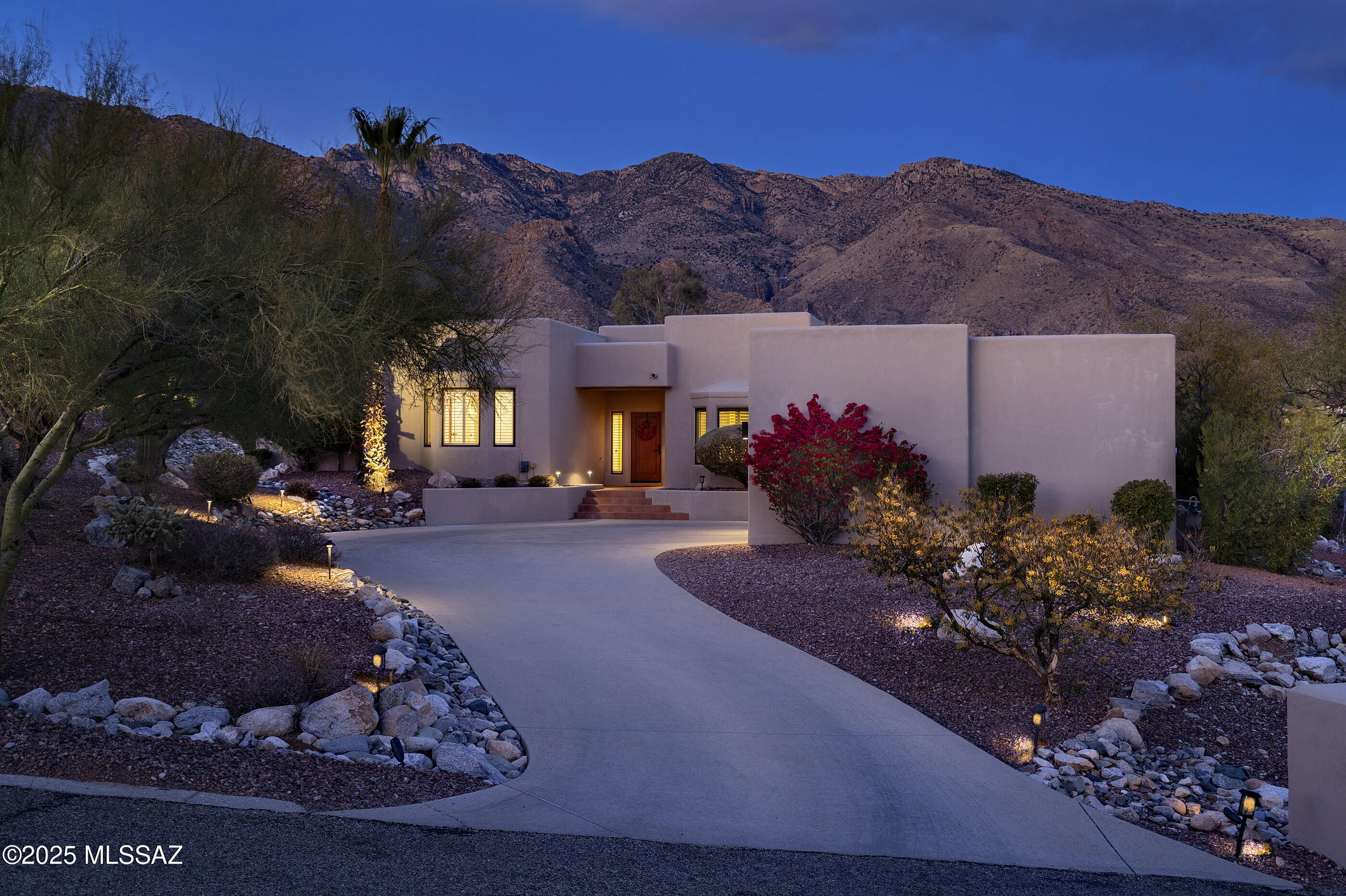 Enjoy unobstructed Catalina Mountain views from this exceptional 5-bedroom, 4-bath custom contemporary home on a premium corner lot on a quiet cul-de-sac in desirable Alta Vista. Carefully renovated and meticulously maintained, this foothills residence features a split bedroom floor plan, new Italian porcelain plank floors, soaring ceilings, and new energy efficient fiberglass  windows showcasing breathtaking mountain views from the moment you enter. The renovated kitchen is a chef's dream, featuring a huge center island, a breakfast bar, custom cabinetry with glass panel door accents, under-cabinet lighting, and a custom backsplash. Stainless steel appliances include a Dacor 6-burner gas cooktop, double ovens, double dishwashers, a warming drawer, Continued... and a walk-in pantry with shelving. The kitchen opens to a warm, inviting family room with a fireplace, perfect for gatherings. Step outside to a spacious covered patio, protected on both sides, creating a true outdoor dining/living room & seamless indoor/outdoor living with majestic mountain views as a backdrop. The North facing backyard offers a pebble tec pool & spa, a grassy area, raised garden bed and ample space for relaxation. The private owner's suite includes a double-sided fireplace shared between the bedroom and bathroom, an oversized tile shower enclosed with glass, a separate soaking tub, new vanities with granite countertops, new fixtures, hardware, lighting, mirrors, and an exquisite walk-in closet with custom cherry wood cabinets and dressers. Three additional bedrooms, a recently renovated hall bath, and a Jack-and-Jill bathroom, each with a separate sink & vanity, occupy the home's west wing. The en-suite fifth bedroom, separate from all other bedrooms, serves perfectly as a guest suite or permanent quarters for extended family or live-in help, with easy garage access. The massive laundry room with new cabinets, granite countertops, a built-in desk, a sink, and a separate locker area for bags and gear is a standout feature. The home is within the highly-rated Catalina Foothills School District #16, including Ventana Vista Elementary School with a Spanish Immersion program. Minutes from Loews Ventana Canyon Resort & Country Club, with golf, tennis, pickleball, fitness facilities, dining, events, and the Ventana Canyon trailhead for hiking. Enjoy privacy and seclusion with great restaurants, bars, and shopping nearby. Whole Foods and Tucson's renowned 133-mile bike path, "The Loop," are less than 10 minutes away.