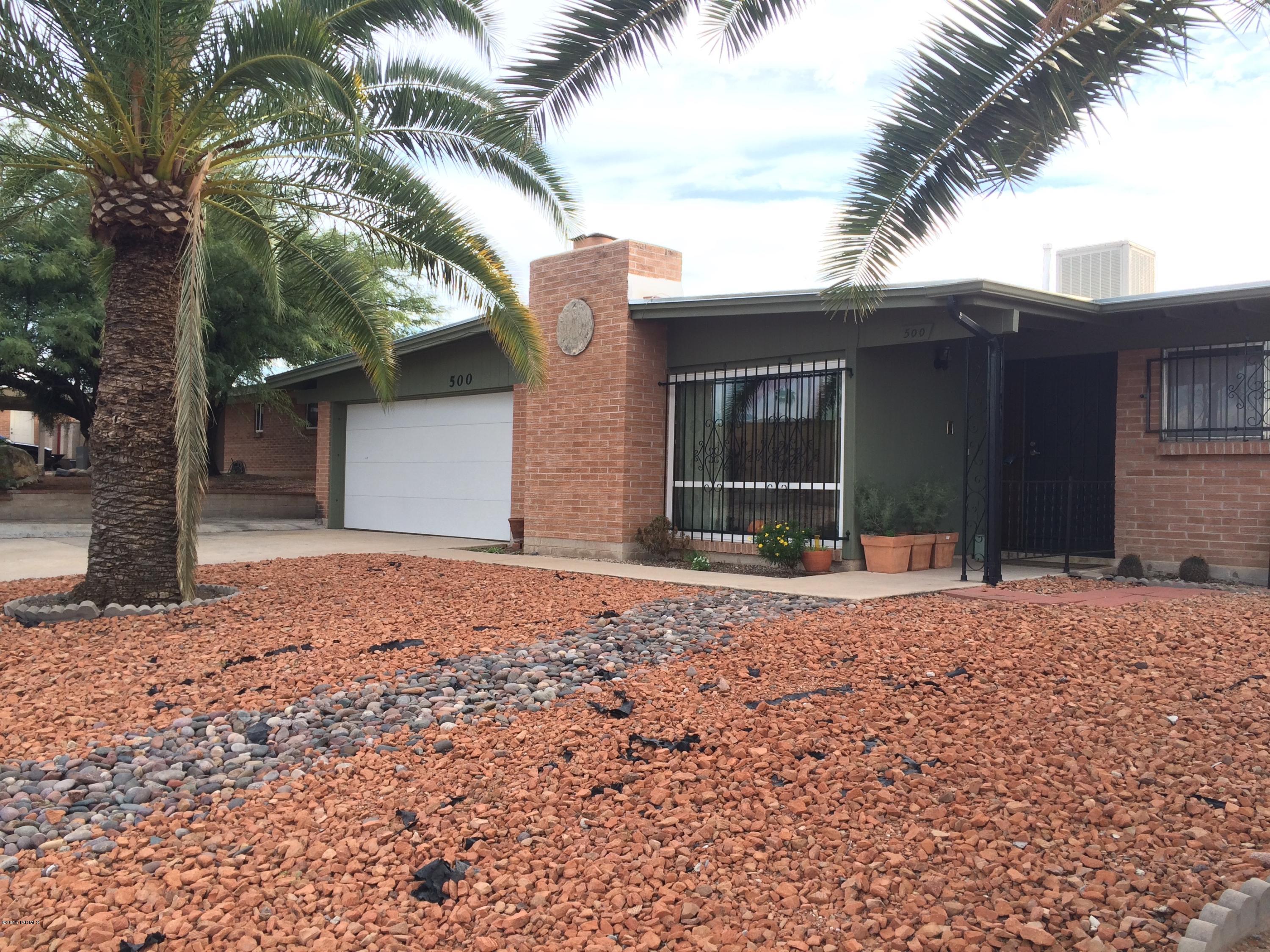 Ideal eastside location masonry brick boasting one of the best split floorpans available. 4br/2.5ba with fantastic hobby man's cave bonus office off Arizona room adding a 5th room option.  Completely tiled throughout with updated neutral warm tan ceramic.  Two gathering spots, spacious living room with wood beam vaulted ceiling, fireplace and kitchen greatroom feel perfect for entertaining.  Looking for a home that accomadates an adult child, friend or mother-in-law?  You just found it!  Easy care big back yard, block wall with extended SUPER gate that easily opens for parking a mobile home, RV or boat.  Built well on corner lot, plenty of parking with handyman's dream garage, work bench and built to last shed in rear yard.  Look no further! Property to be sold ''AS IS'' ready to be loved