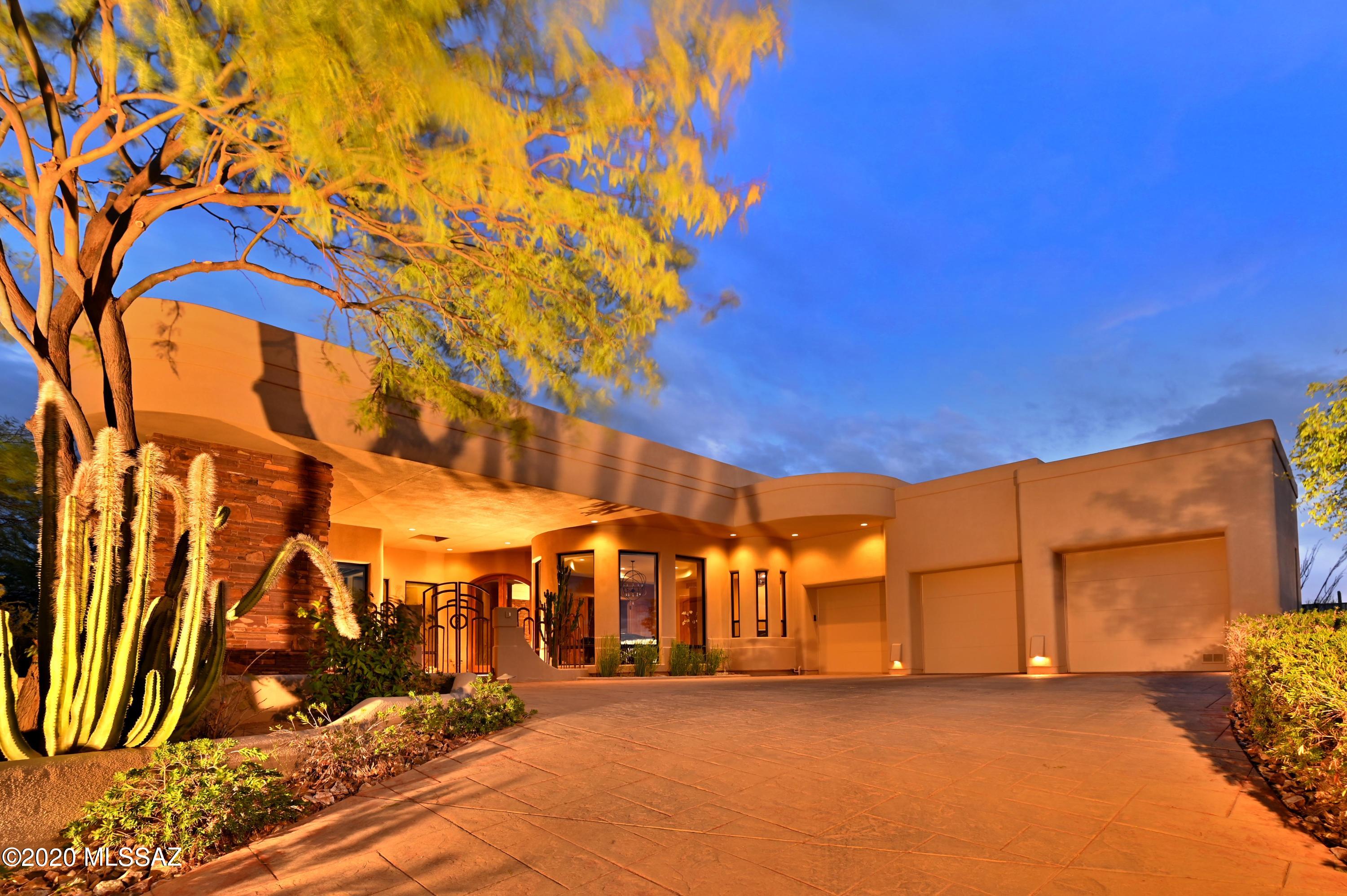 Amazing 3/3 gated contemporary home with over 3400sf of luxury estate living. This home has it all with unbeatable resort level Southern Arizona outdoor living year-round. Inside this property features large rooms, split bedroom plan for privacy, and opulent finishes throughout. Outside is where this home exceeds all expectations with extensive flagstone patio space. Views abound of entire mountain ranges, majestic saguaros atop a wash with boulder outcrops (some with Native Petrographs over 800 years old). A premium location in the exclusive gated HoneyBee provides an excellent Oro Valley location near shopping, dining, world class hiking and biking. The property is near an abundance of raw Arizona natural beauty. Priced to sell schedule you showing today on this hard to duplicate estate!