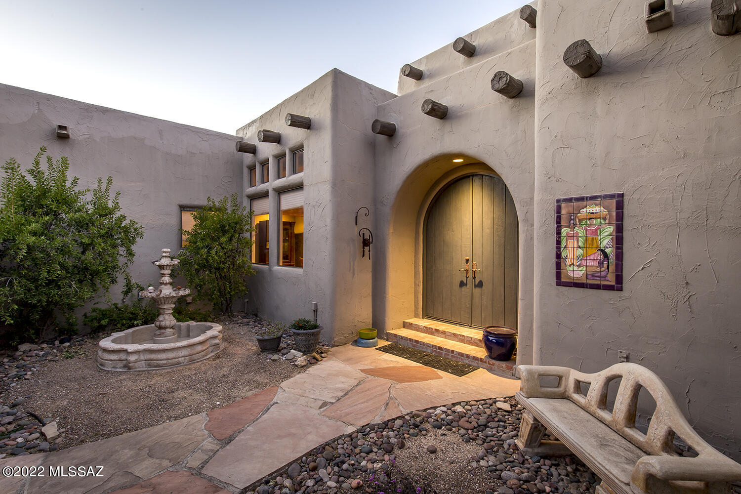 This unique Santa Fe home was designed by Ron Robinette. The home is set back on a cul-de-sac and situated on a private acre lot. The property backs to large open desert area which adds to the serene feeling of the foothills. The wonderful circle driveway leading you to the front courtyard welcomes your guests when coming to visit. The attention to detail does not stop as you walkthrough the entire property. The peaceful courtyard fountain, the arch entry doors, impressive architecture, vigas, barrel rolled ceilings and hallways, niches, a gourmet kitchen w/ Talavera tile counters, a split floorplan, a den that can be used as a 4th bedroom and wonderful lighting throughout the home. Your patio was designed for entertaining and enjoying the gorgeous mountain views. The home also has some.. ...sustainable features such as solar panels and a 1000 gal passive water catchment system. The landscaping is mature and the pool/spa are ready to be enjoyed. Come see this one of a kind home today!