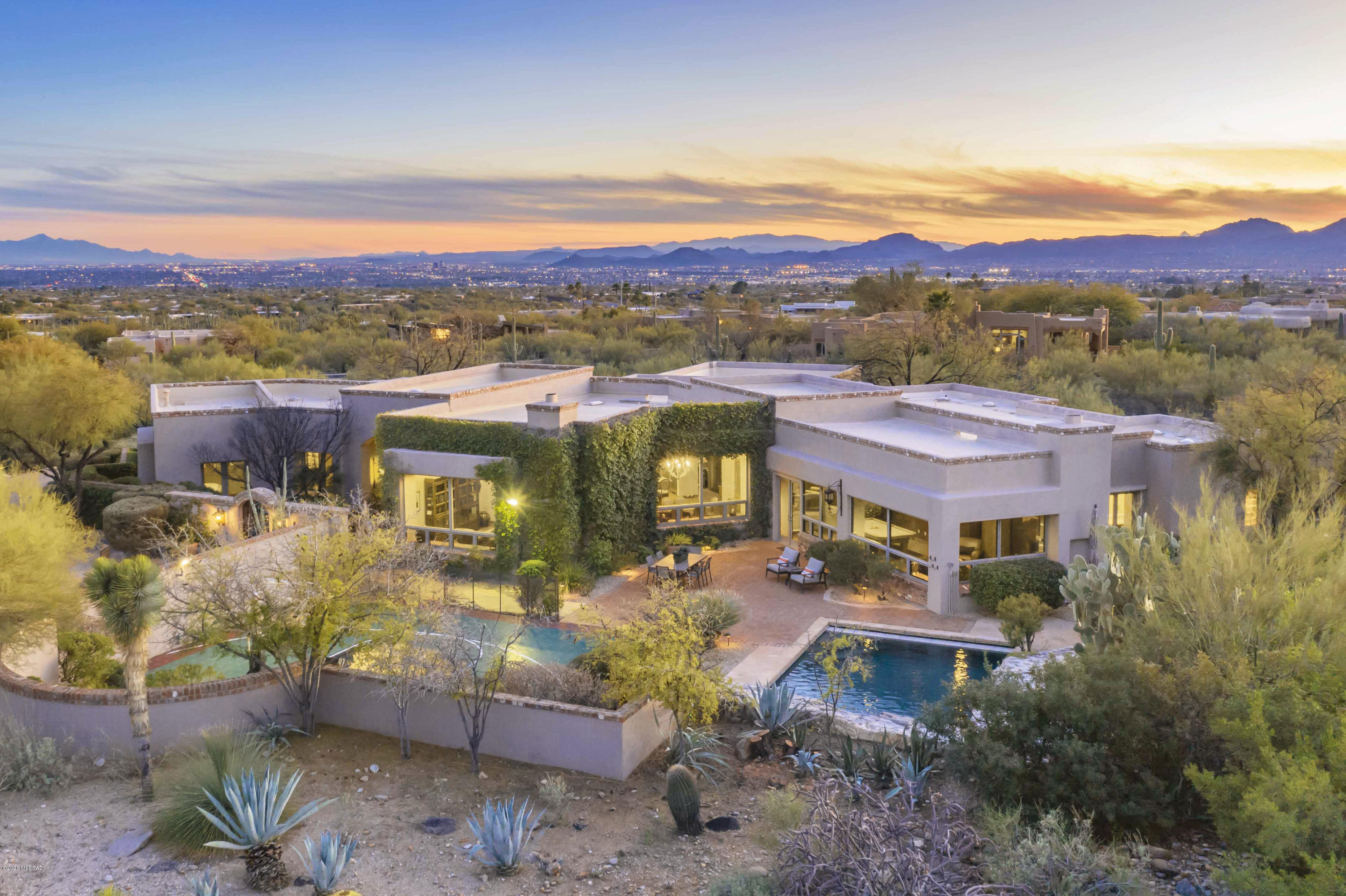 A true Arizona style masterpiece w/mtn views in prestigious gated Pima Canyon Estates. Beautiful front gated brick courtyd w/iron & glass front dr, 6154 sq.ft. Exquisite Living Rm w/12 ft. High beam ceilings, walls of wood cased windows, dramatic fireplace, formal dining rm w/ chandelier, gourmet island kit w/quartzite countertops, designer tile backsplash, Dacor stainless
appliances, 6 burner gas range, dble ovens, 2 dishwashers, wine cooler, SubZero, pantry, bkfst area opens to family rm + billiard rm w/FP, 8 ft. French drs & scored concrete flrs thruout, 5 BR's + study +  exercise rm, 4 BA's  w/quartzite countertops, 2 mstr closets, laundry rm , masonry/stucco & 3 car gar. Resort like bkyd w/pool,spa, water feature, sport court, BBQ, lush landscaping, Dog run, long driveway, views!