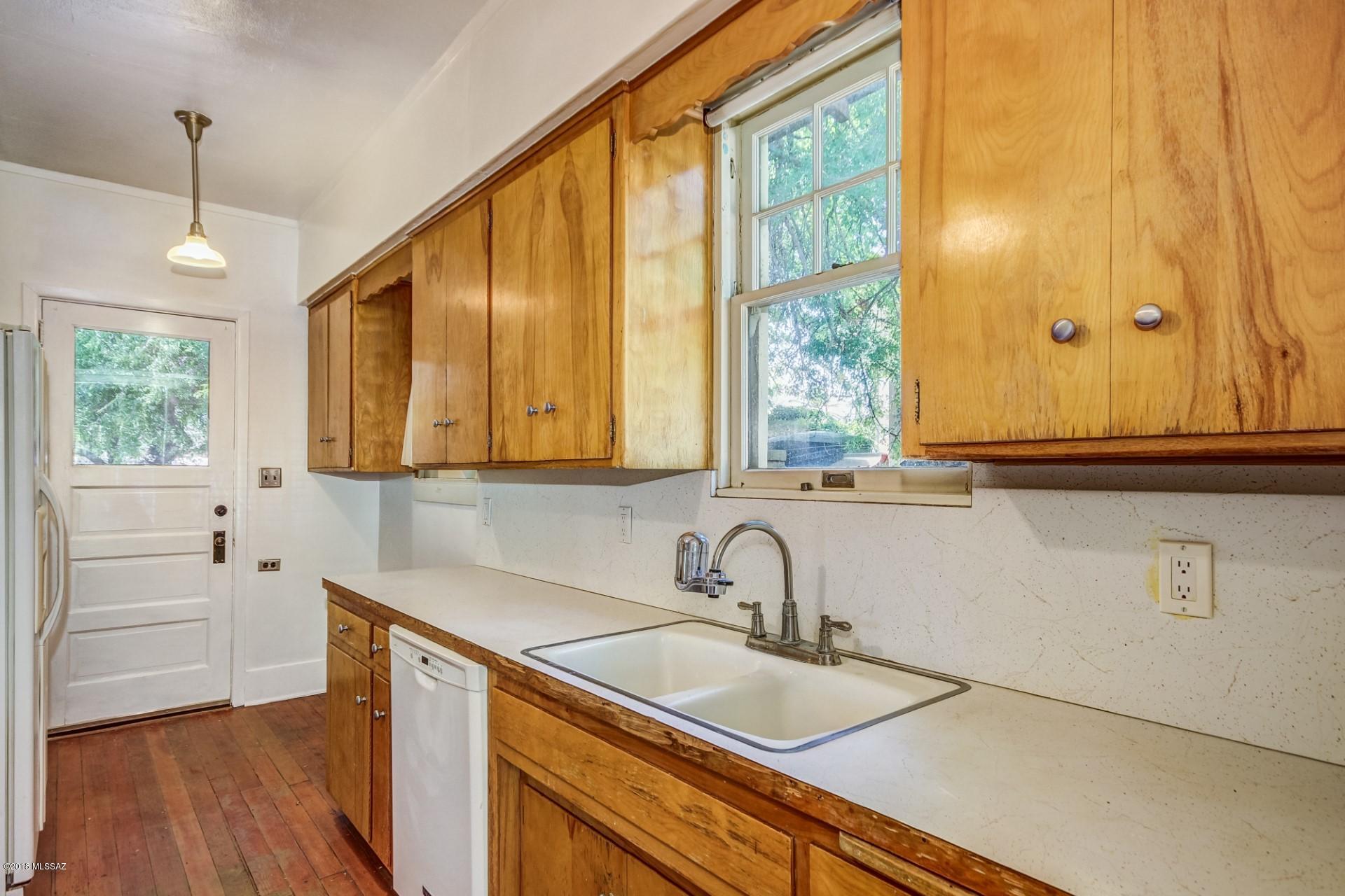 Classic California style bungalow built in 1920 with historical charm. Large covered patio - hardwood floors in main house- stained concrete floors in guest house, large mature hardy trees with lots of shade.Spacious lot.  0riginal window casings.  Cozy - original working fireplace.  Spacious bedrooms.  Vintage bathroom loaded with classic tile.  Lots of natural light and windows.  Backyard is an oasis.  Off street parking in back for 2 cars.  Recently remodeled guest house.  Makes an excellent rental or studio. Across the street is Catalina park and splash park.  Walk to the UofA, coffee shops, restaurants, and Street Car.  Will sell fast.  Be prepared for multiple offers.  Give seller 48 hrs to respond to offers.  Seller is licensed to sell Real Estate in the state of Arizona