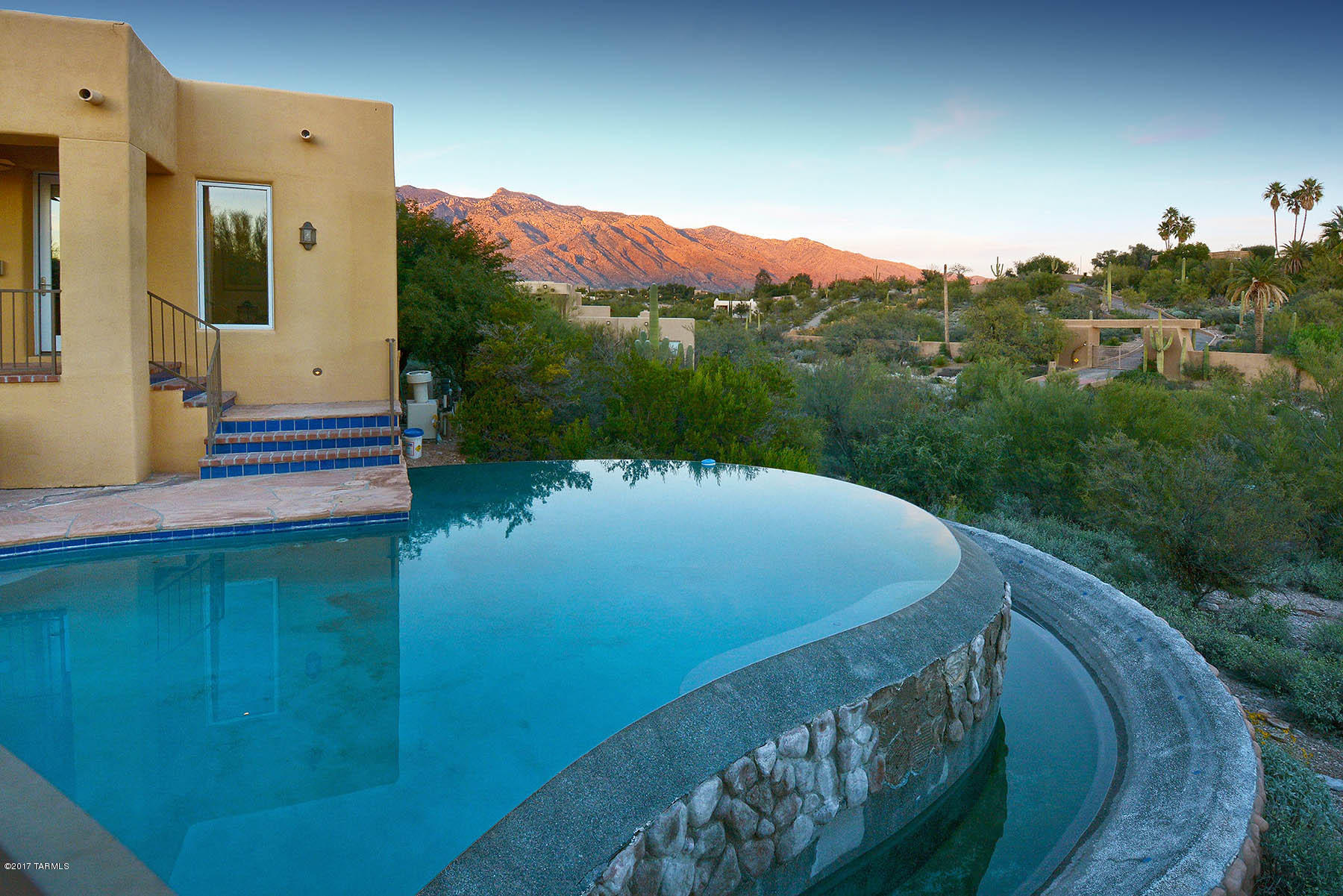 A GEM!  Single story family home built by Jeff Franks and designed by Mike Franks!     Beautiful SW contemporary home updated and maintained in beautiful, gated, La Paloma Estates.A comfortable, spacious home with 4BR's and 3 full baths. Split bedroom plan. Gourmet kitchen with Dacor double ovens,and gas cook top. Bosch dishwasher and Sub Zero frig SS appliances.Beautiful granite counters.Multiple inviting bricked patios with fireplaces. Private negative edge pool and spa with beautiful mountain views. Tons of storage! An oversize 3 car garage with workshop space.  Room to build more garage space if needed.   All on one level.