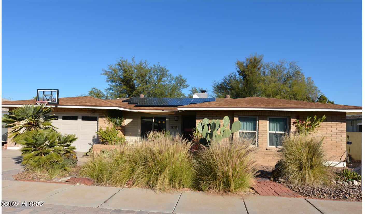 Beautiful home with stunning mountain view. This home has a cozy living room with beehive fireplace. New windows, doors and roof. The backyard patio has been enclosed and made into an Arizona room for more privacy. The backroom can be used for a studio, workshop or made into a spare bedroom. Courtyard entry and North facing large backyard with mature landscaping and unobstructed views of the Catalina Mountains.