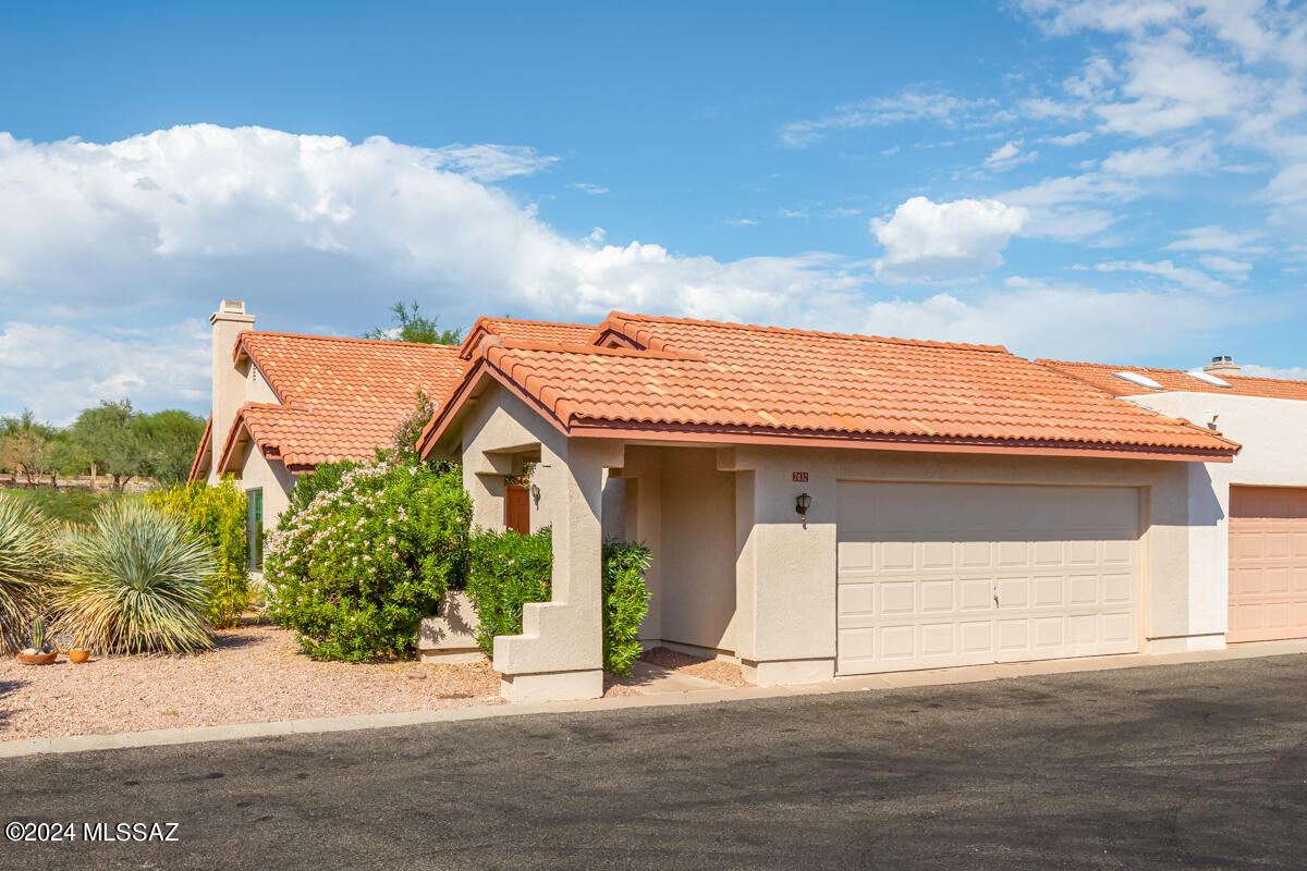 This is the One! Townhome inside the gates of Omni Tucson National. Located on the 4th green of the Sonoran Golf Course. This end unit sits at the end of a cul de sac with guest parking across the street for convenience. Light and bright with many large windows to let the flora and fauna of the desert in. Split bedroom plan with a wonderful AZ Room built for your comfort with air conditioning and heat to use in all seasons. Covered patio to sit and relax with a cold beverage and look out onto the course. 2 Car Garage! HOA covers many items to include pool/spa, landscaping, trash collection, streets and gate.