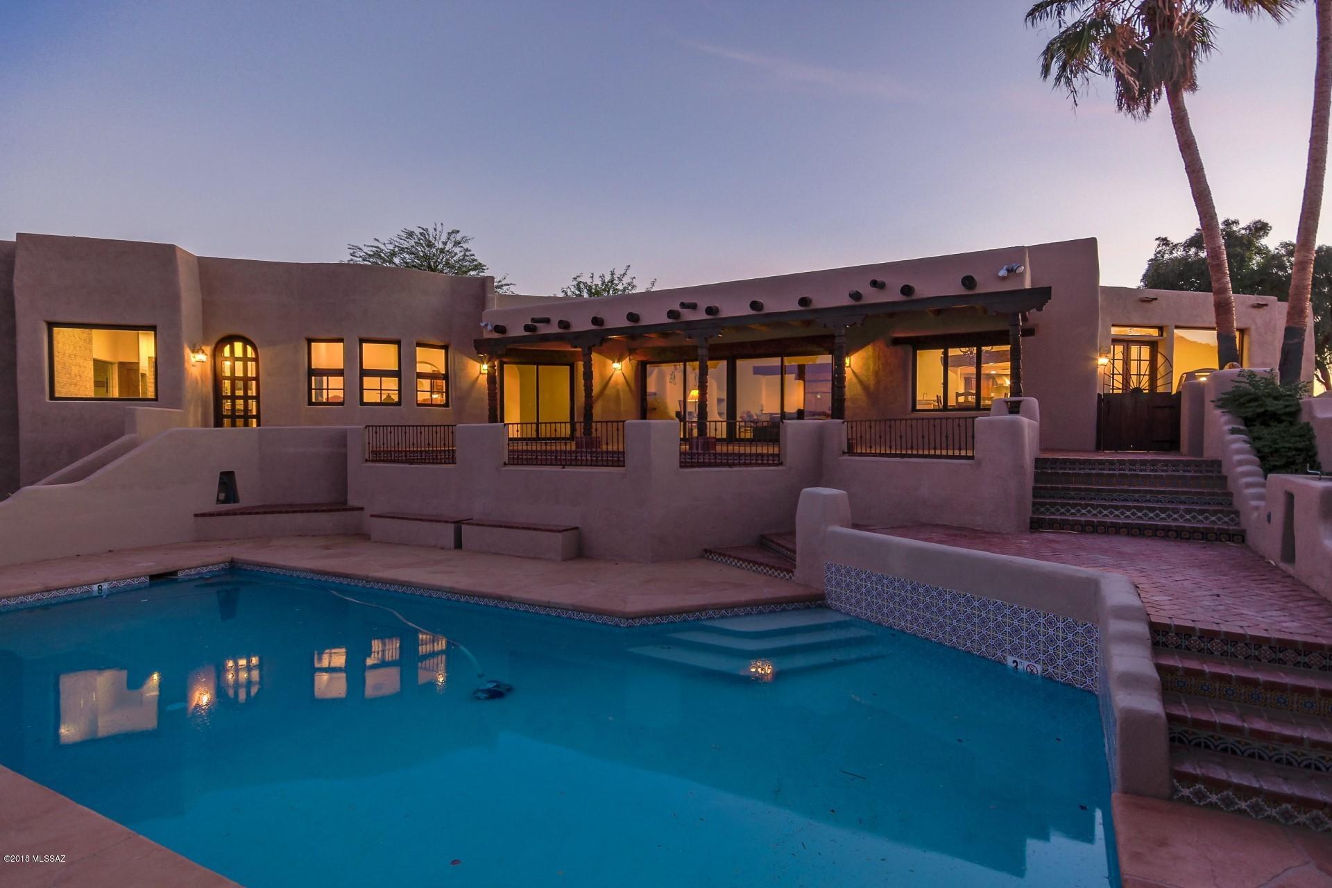 Majestic Mountain Views. Extraordinary estate nestled in the esteemed Catalina Foothills. Authentic Old World charm and elegance are featured. Wood beamed viga ceilings, brick floors, fireplace, hand painted Mexican tile and custom detailing throughout. A chef's kitchen includes stainless viking appliances, double oven  6 burner gas stove and huge pantry. The     spectacular master suite boosts a sitting area, 3 walk in closets, steam shower, personal laundry facility and luxurious soaking tub. Expansive covered patios, private courtyard, inviting pool, outdoor fireplace, and vast grounds. Detached guest house with spiral staircase, loft and breathtaking views. All this close to La Encantada Mall and the foothills best restaurants. The ultimate home for entertaining. Come take a View!
