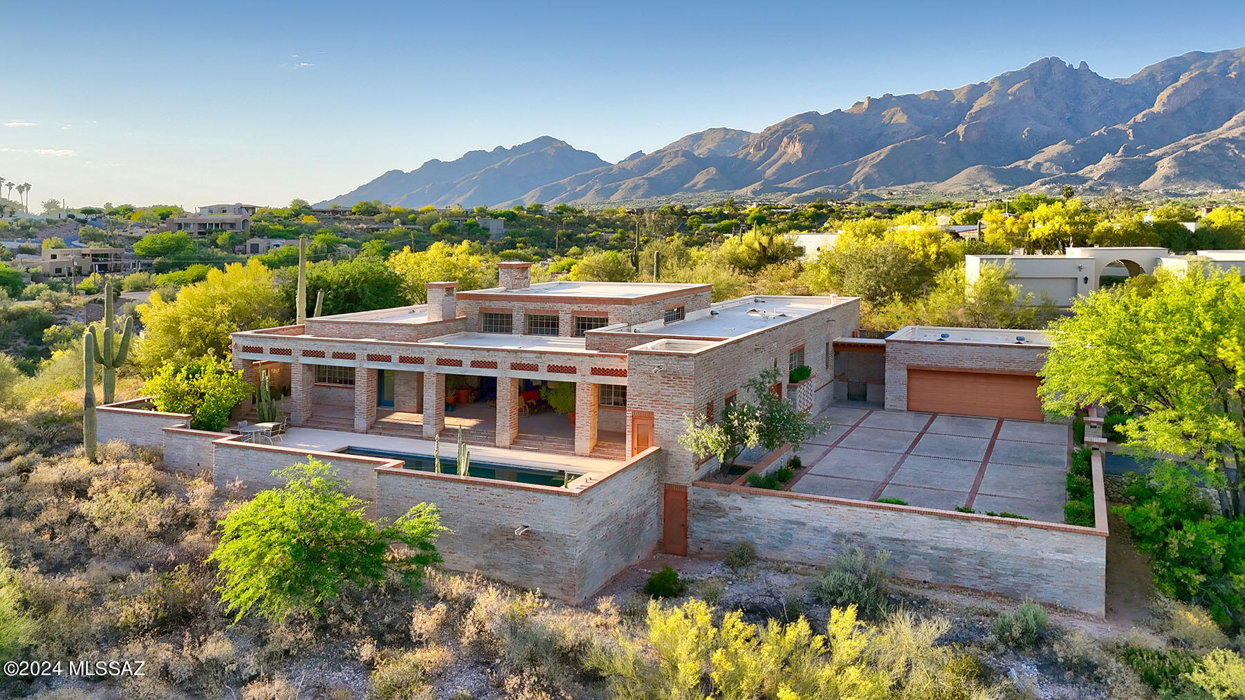 Stunning Sunrise, City, Sunset, Mountain and Desert Views, designed by architect James Gresham. Ultimate Great Room with concrete beams/lentils/fireplace mantel and clear Douglas Fir Ceiling. True North/South orientation, Steel Sash windows, Pella exterior doors, solid wood interior doors and jams, Adobe and Imperial Plaster walls, abundance of Coppes and custom cabinetry, Roman Shades and Hunter Douglas window coverings,  North/South covered flagstone patios, outdoor pool bath, spacious Auto Court for guest parking, all the amenities. Most furnishings available.  Owner is a licensed real estate agent.