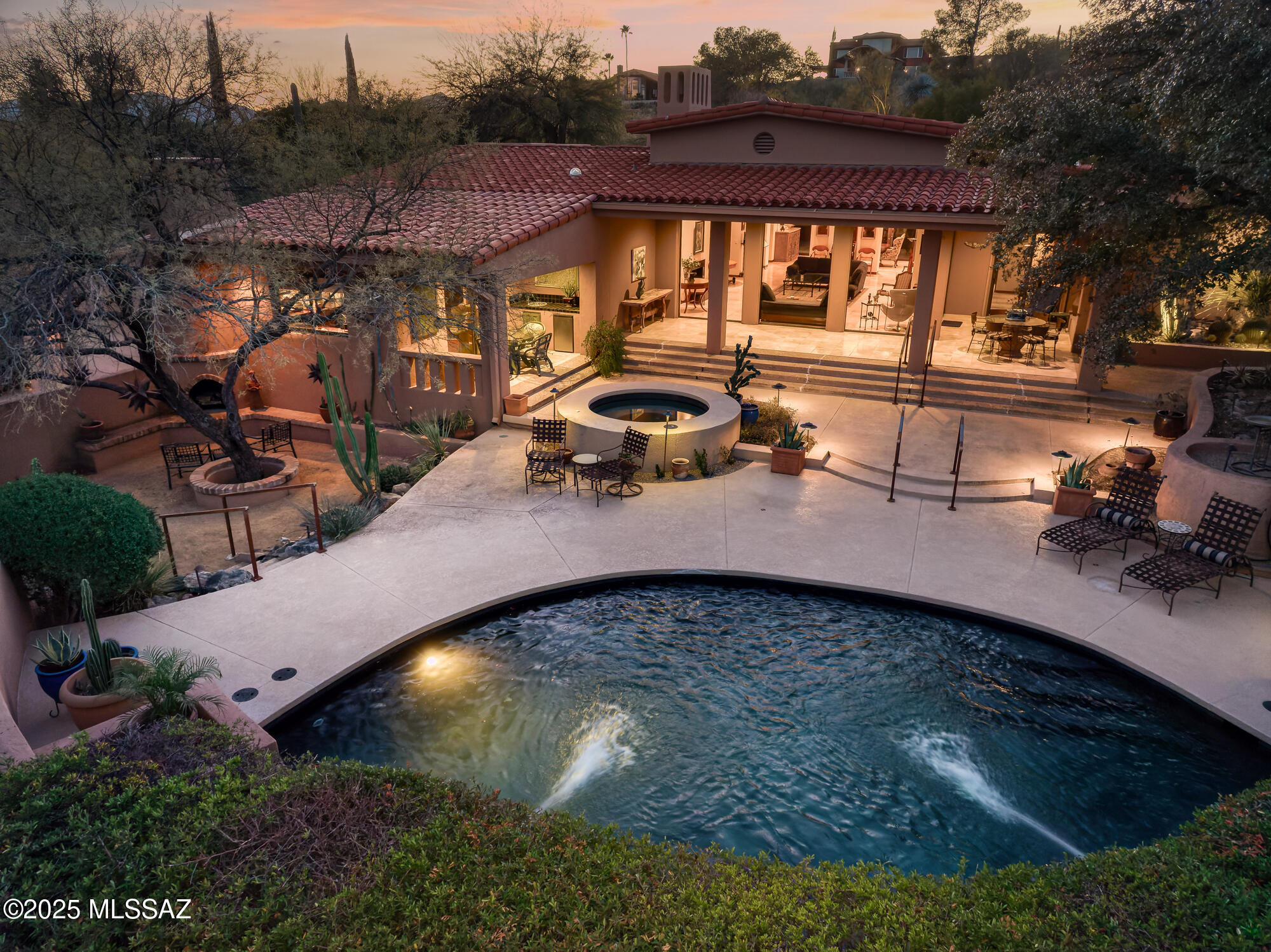 Just off the golf course in Tucson National this magnificent residence offers breathtaking panoramic mountain views in an entirely private setting w/gated courtyards, lush desert landscaping & custom lighting surround.Inside the main living area expansive walls of windows frame incredible views, cathedral ceilings w/elegant wood trim soar above rich built-in shelving. Dreamy chef's kitchen enjoys an oversized SubZero refrigerator/freezer, double ovens, Viking 6-burner cooktop, breakfast bar, custom cherry cabinetry, fireplace/sitting area & eat-in casual dining. 2 luxurious primary suites, bonus room/office/den, guest rm that doubles as media room, 4 fireplaces, library & elegant dining room all in an open floor plan design with fantastic quality finishes. The rear yard rivals any resort!