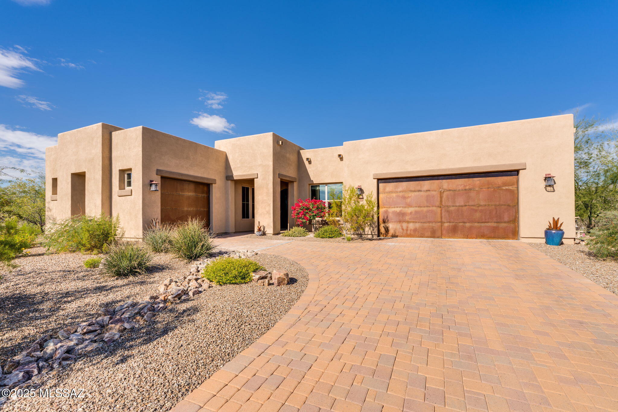 Nestled in the exclusive gated community of Tortolita Vista, this breathtaking home showcases unrivaled Tortolita Mountain views and refined desert living. This 3BD/2.5BA, plus den offers 2,795 sq. ft. of beautifully designed living space with a 4 car garage. The open-concept layout features a spacious great room that flows effortlessly into the kitchen, ideal for entertaining or everyday comfort. The expansive Owner's Suite offers a spa-like retreat; bath boasts dual vanities, soaking tub, large walk-in shower, and a generous walk-in closet. Split floor plan provides privacy for guests, with two additional bedrooms connected by a Jack-and-Jill bath. Step outside to an extended paver patio where tranquility and stunning desert scenery await perfect for dining, lounging, or capturing those unforgettable Tortolita Mountains views and Sunsets.  Home hosts whole-house filtration system and pre-wiring for solar, recently the exterior painted and brand-new irrigation system.  All of this is just minutes from premier hiking, biking, golf and more making this home the ultimate blend of luxury, comfort and outdoor living.