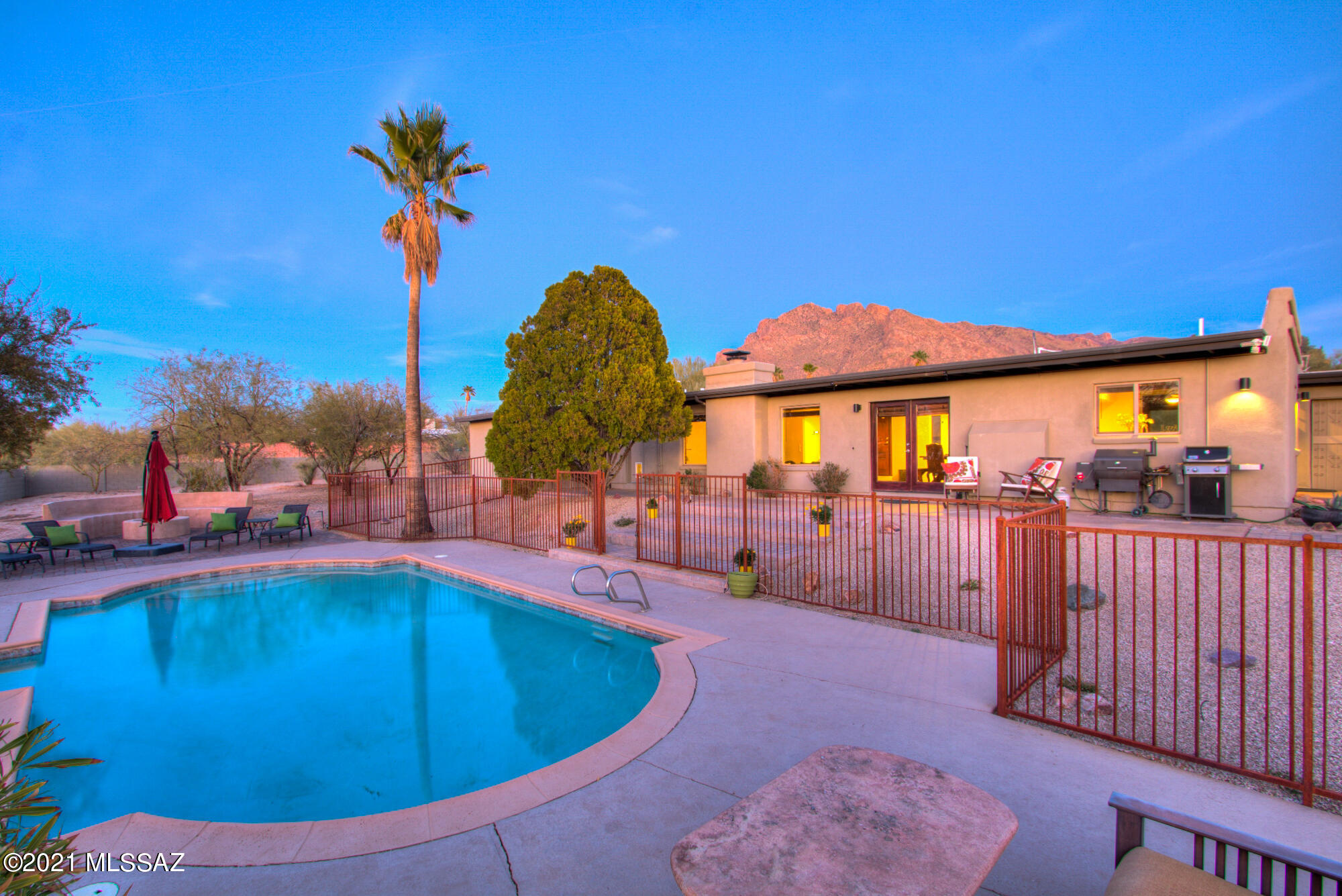 Sellers will accept or counter offers from $600,000 to $625,000. This is the Casas Adobes gem you have been waiting for! No details were spared in this stunning home, impeccably maintained  and tastefully updated in every way. Resting in the shadows of the Catalina Mountains this 4 bedroom 2.5 bath home with a pool sits on a beautifully landscaped .83 acre lot in a prime Oro Valley location. Granite countertops, stainless steel appliances, tiled showers, modern tile flooring, custom ironwork including fencing, gates, an amazing shade awning and courtyard entry are just a few of the upgrades on the list. With no HOA and plenty of space for all of your toys this home definitely will not disappoint! Schedule your private showing today!