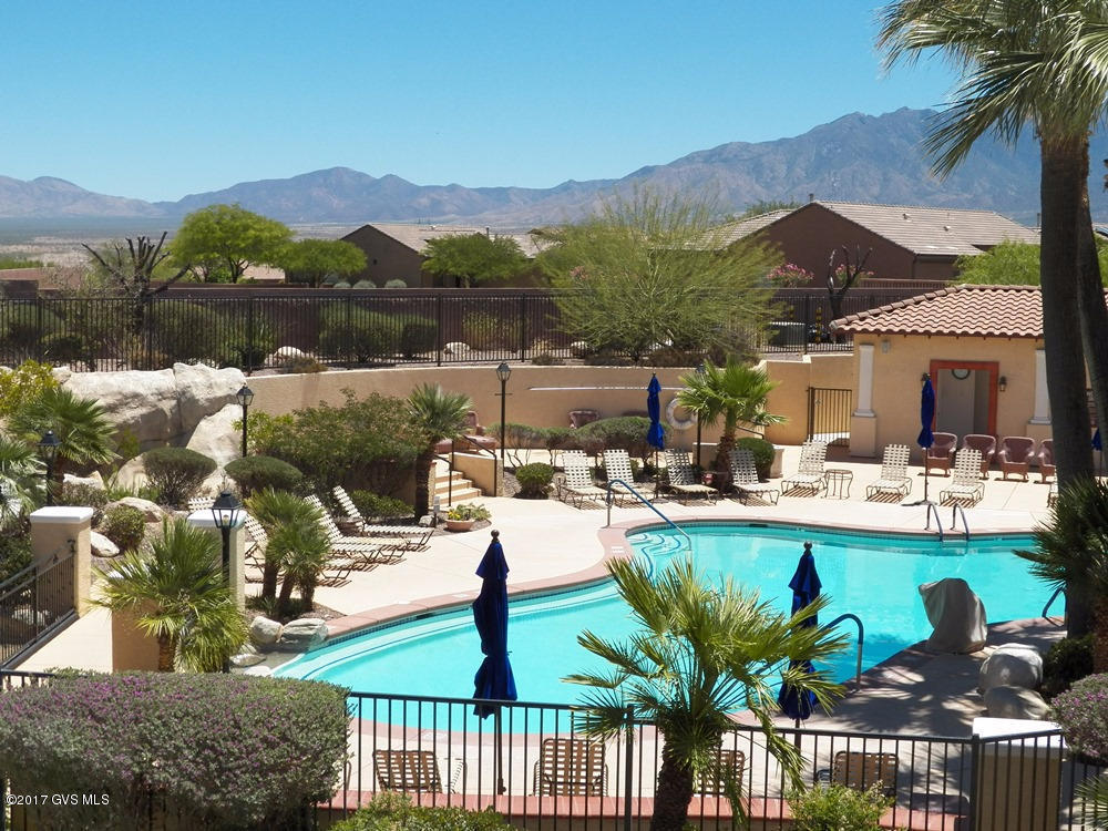 The Best Views of any condo in this resort. Located in the hotel registration building central to the resort's pool, spa, BBQ area. The sunrises and sunsets against the Santa Rita Mountain are spectacular from the great room, master bedroom suite or covered rear balcony. A rainbow of colors dance across the golf course, lake and valley with palm trees swaying in the breeze. This luxurious , fully furnished 2BR, 2BA condo features top-of-the-line granite, stainless steel appliances, new flooring, executive height vanities, gas fireplace. The most direct access to the resort amenities  pool, spa, BBQ, fitness center and golf clubhouse/restaurant. All maintenance, utilities are included in the monthly HOA. Great flexibility as a seasonal/vacation destination or an  excellent investment/rental through Wyndam Resorts.