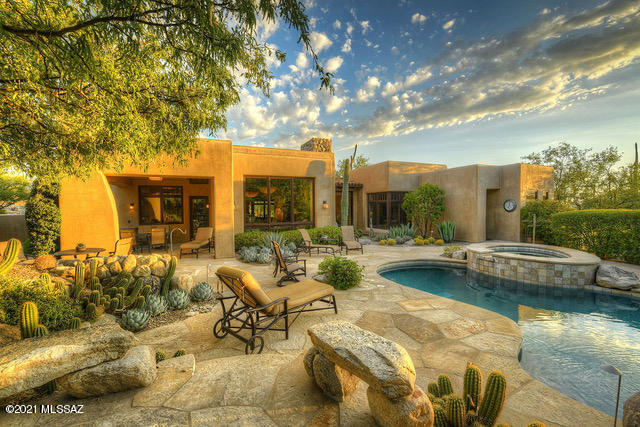 Impeccable Mediterranean Masterpiece built by Taos Construction, Ben Cole architect. Exclusively located behind guarded Pima Reserve in Pima Canyon Est. Dramatic mtn views near the National Forest, all interior/exterior stone featured thru-out is from the original lot. Two private patios offering shaded extra living space. Interior shares earth tones, high ceilings framed by wood beams, clerestory windows & arched doorways. Solid Alder doors & Loewen picture windows. Gourmet kitchen offers high end appl., spacious working island w/prep sink. Great rm has priceless mtn views & opens to the large dining area. Secluded master suite abounds luxury. Guests have their own quarters including living space & 2 en-suite rooms. Retreat outdoors to enjoy the soothing waterfall, pool & spa.