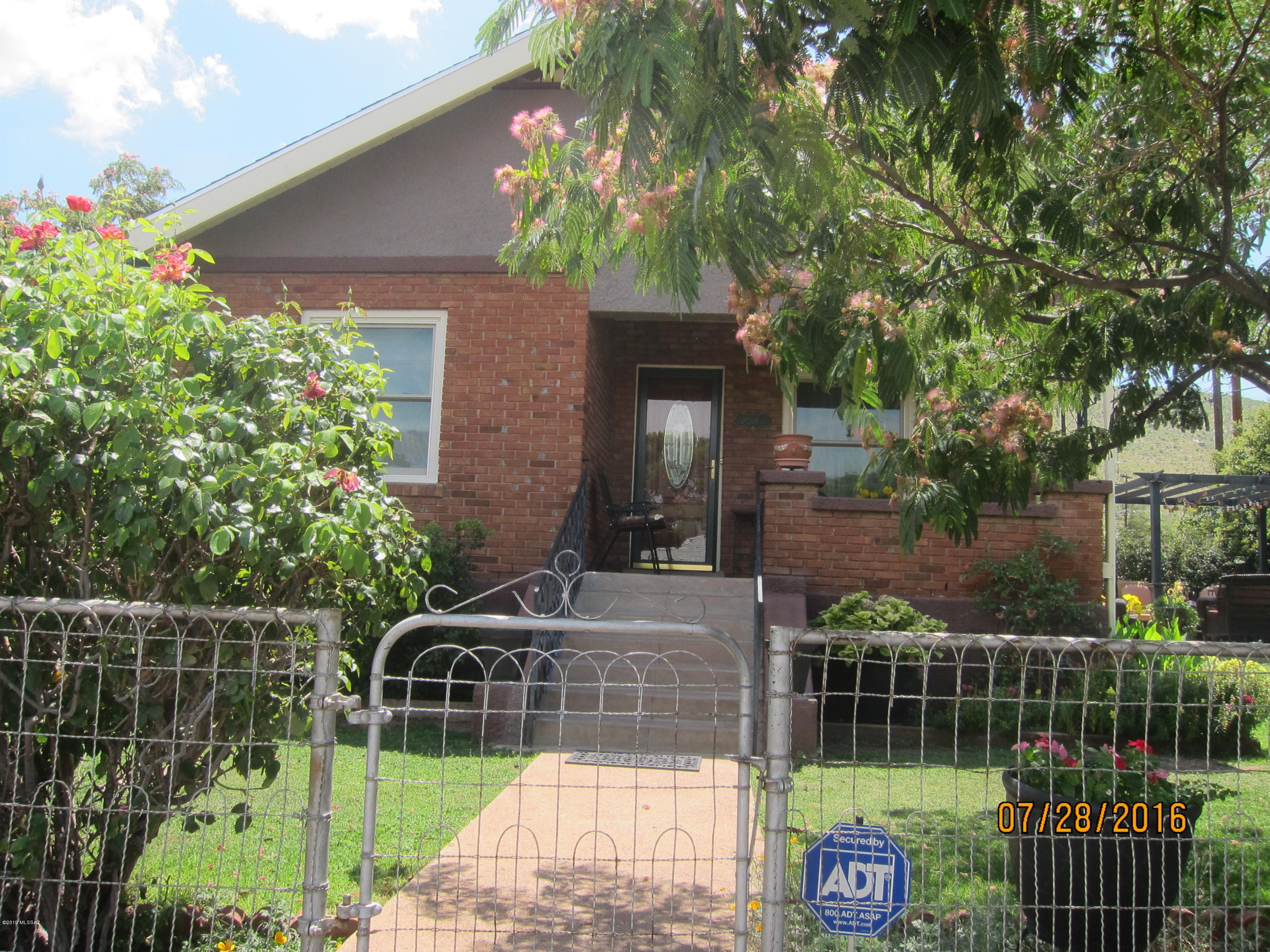 Upgraded and well maintained Bisbee home with newly refinished Hard Wood Floors, Air Conditioning, Vintage 1942 Metal Cabinets, Anderson Windows, Crown Molding, ADT Security System and 30 YR Architectural Shingled Roof with enameled fascia (2006).  Beautiful landscaping and privacy.  Nice patio for relaxing and bricked side yard for easy maintenance. Corner lot in nice quiet neighborhood.