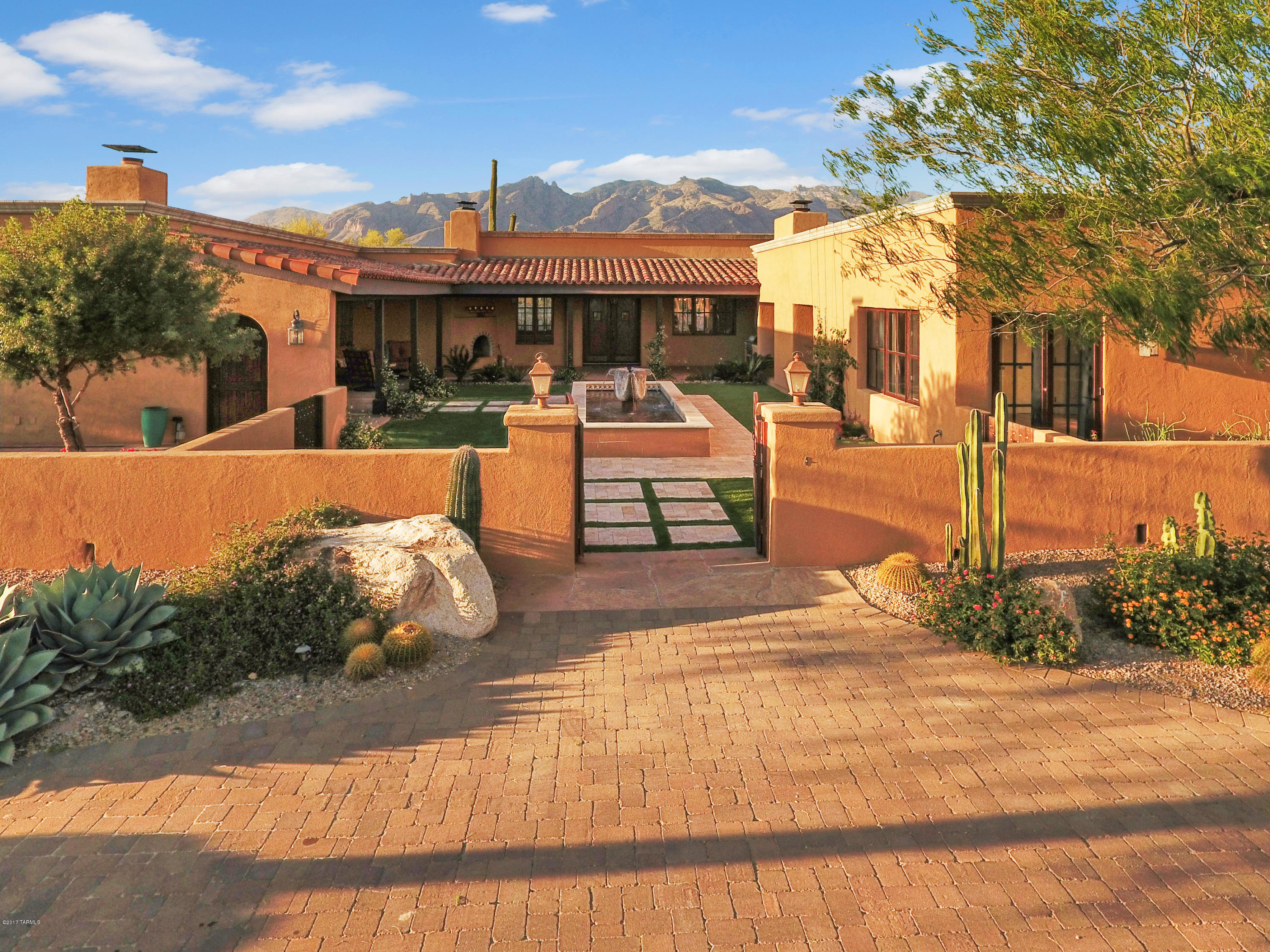 Located within gated Cat#10-Magnificent Spanish colonial situated at the end of a quiet cul-de-sac on a 1.9 acre lot w/beautiful City & Mtn views! This hilltop Hacienda has Tremendous Attention to Detail. Enter up a long driveway covered in Pavers, then thru a Charming Courtyard with a Fountain, Builtin BBQ, fp, surrounded by U-shaped covered Porches off of bdrms, & Living areas. Personality-filled home w/high ceilings, Wonderful Finishes, Cantera stone FP, Custom Mesquite Cabinetry, Custom Mexican Tiles & Wood Beams. You'll love cooking in this Remodeled Kitchen (2013) w/Large Center Island, informal dining & FP. One wing has a Spacious Master Bdrm w/FP & French doors to the Spa area & a Custom office/library.