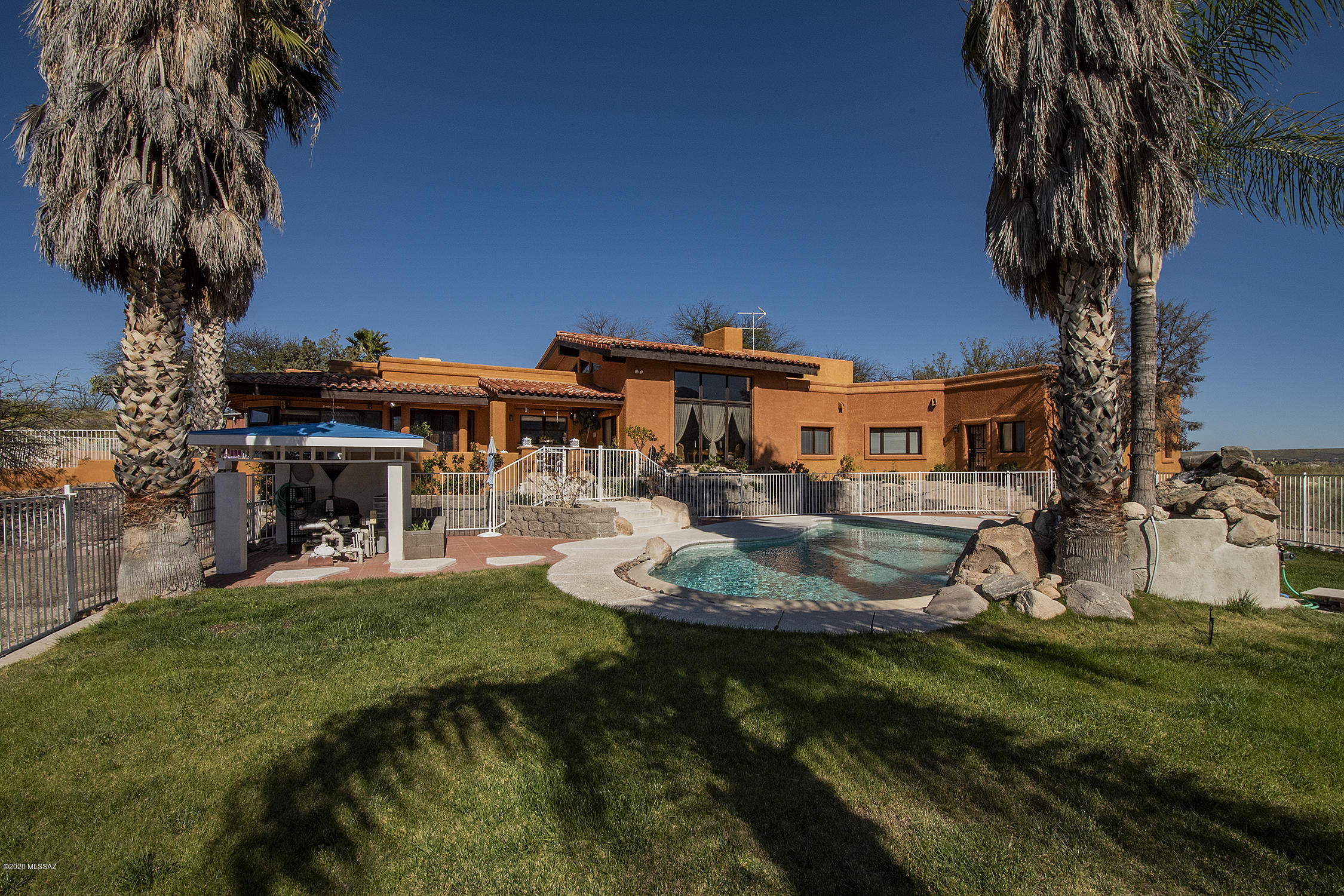 ONE of kind VIEWS  from luxurious  Master bedroom, impeccable living room, and covered patio for breakfast.
National forest at back with Catalina Mts, over 50000 acres of trails to explore. Its like an island, with no neighbors. Has horse privileges, for riding and reflecting Set on 6.8 acres of beautiful rolling hills for elbow room. Has private offices and library to really be comfortable for working at home. The pool is just the right size. If you have a calling for horticulture there is a Green House to get in touch with nature. There is a LOT more!! Vacuum system, multiple a/c,evaporate cooling units, solar hot water heater, additional  pad of 25'x25 to  build  a workshops, Guest house two bedrooms.1100 water harvesting  tank, no HOA .Newer septic   window coverings convey Private GA
