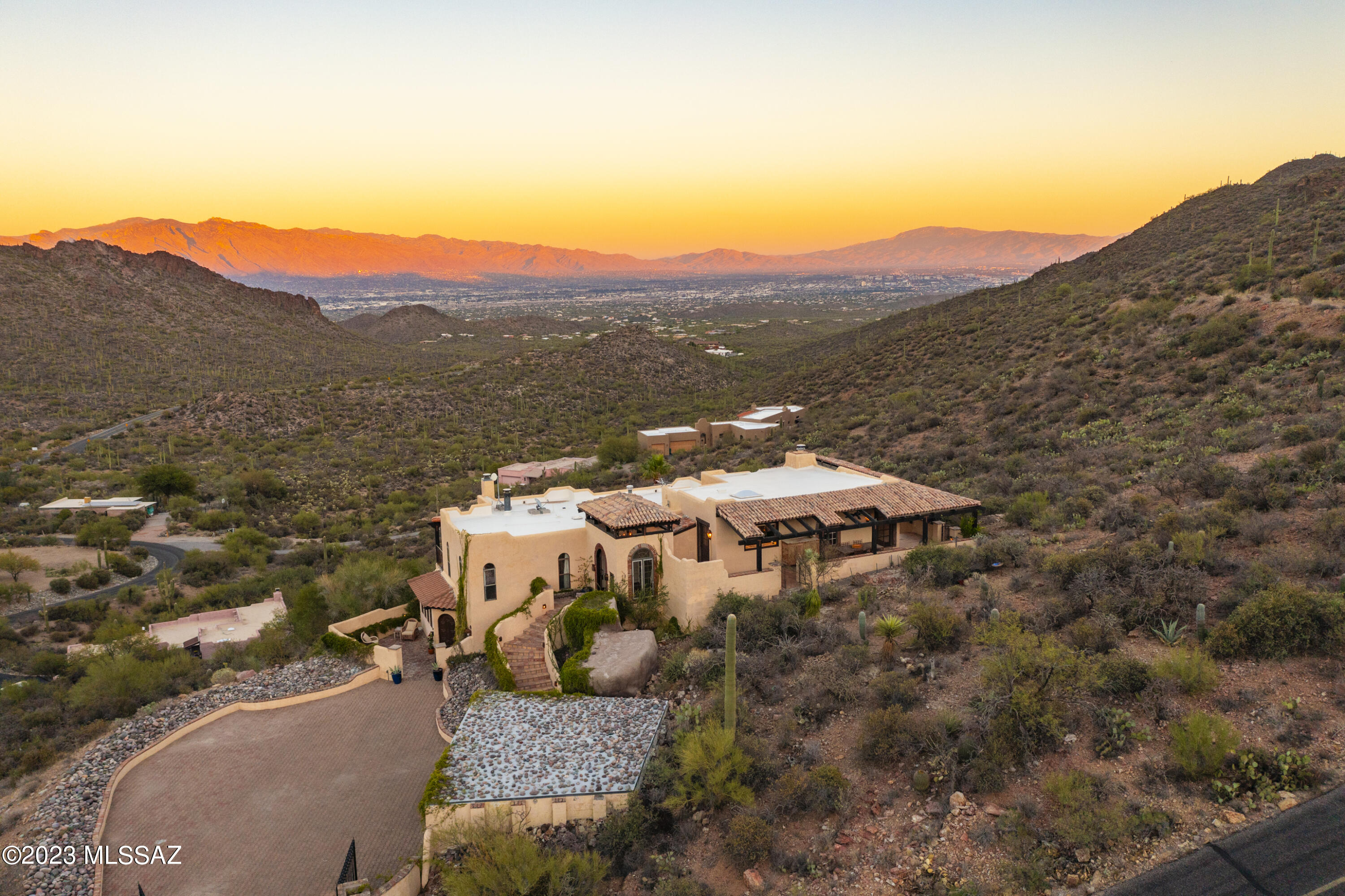 Distinguished mountainside residence in Trails End Estates, bordering Tucson Mountain Park, north of Gates Pass. This majestic marvel is perched on a high overlook - w/ breathtaking panoramic views in every direction (mountain, desert, city, sunrise, and sunset!). Indoor features include tasteful wood floors, spectacular wide windows, cozy gas fireplaces, updated kitchen (w/ quartz counters, breakfast-bar, & electric range), & expansive finished separate downstairs guest quarters with private entry, walk-in closet, & en-suite full bathroom. Outside, find serene sanctuary spaces & exquisite entertainment enclaves - impressive central court-style gates driveway w/ guard-booth, stunning veranda w/ terraced wrap-around patio & walkways (plus built-in wood/charcoal barbecue and outdoor gas fire-bowl). Must see to truly appreciate - especially during evening twilight!

Property location makes it moments away from world renowned Tucson attractions - Starr Pass (including JW Marriott Resort & Spa, plus Troon Club), Arizona Sonora Desert Museum, International Wildlife Museum, Old Tucson Studios - along with easy access to The University of Arizona, Downtown, and more!

*See full list of upgrades and sensational aerial video.