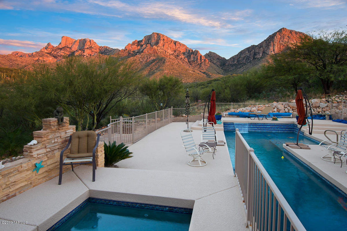 Seller shall entertain and/or counter offers between $1,000,000 - $1,150,000. Peaceful Desert Retreat perched high above Oro Valley in Prestigious, Guard Gated La Reserve. Surrounded by Saguaro studded Ridges & backing La Reserve Wilderness boundary for lasting privacy, this 4,971sf owner designed, custom home builds upon the Frank Lloyd Wright vision of seamlessly blending colors & textures of nature w/comforts of home! Marked by walls of windows that form a perfect frame for the mesmerizing Pusch Ridge views, stacked stone columns, Red Oak floors, Alder cabinets & luminous skylights throughout! Open concept plan & luxurious backyard oasis boasting a sparkling lap pool w/cascading waterfall & fully equipped outdoor kitchen & gas fire pit, inspire grand gatherings! Gaze upon the ever-changing colors in the spectacular Arizona sky as the sun descends beyond the city.