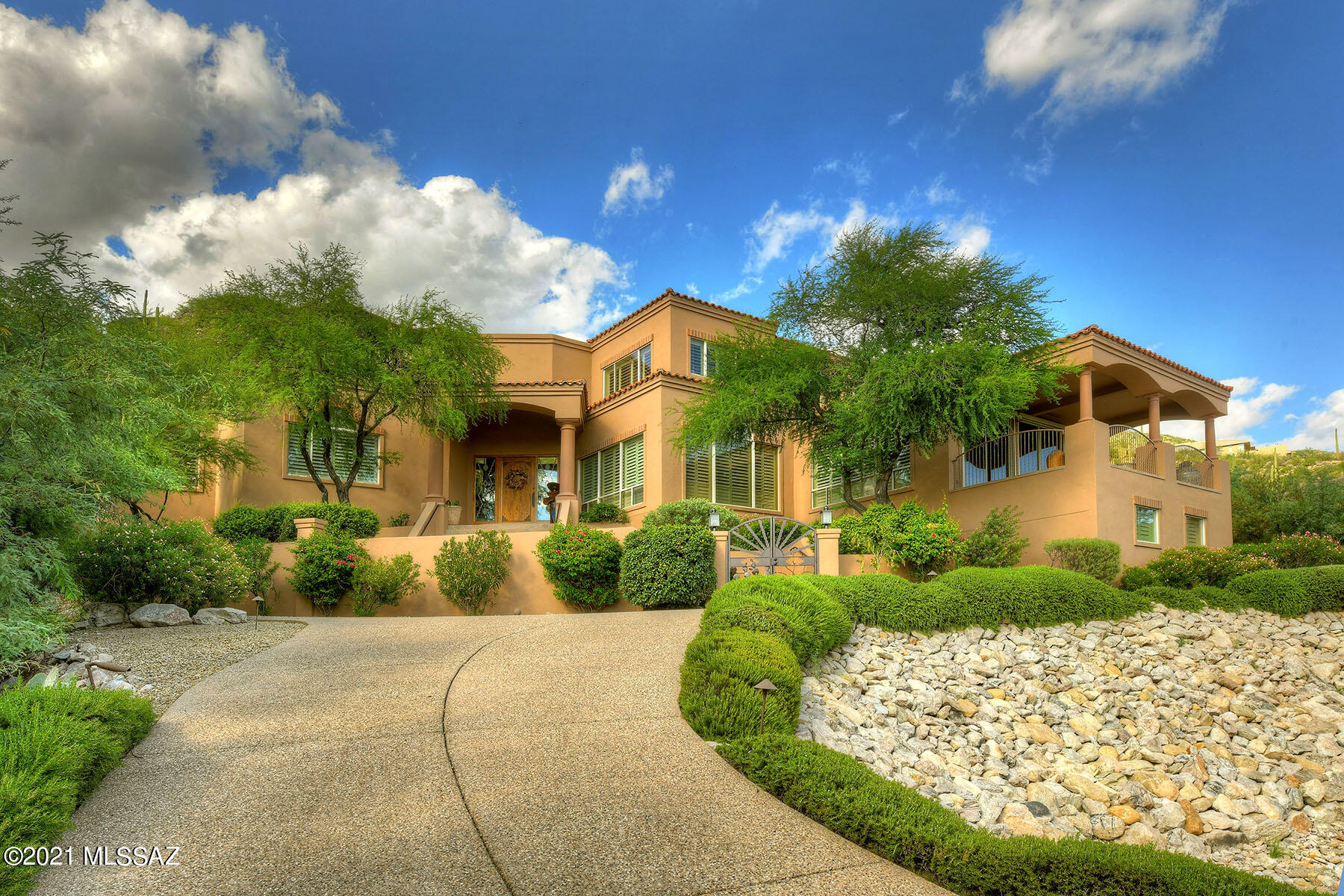 Seller will accept or counter offers from $1,595,000 to $1,695,000.  This spectacular Mediterranean/contemporary is nestled on a glorious 1.16 acre hillside lot backing up to the Catalina Mountains and offering sweeping Tucson city views!  Located in guard-gated Ventana Canyon Estates, this 5,067 sq. ft. home includes 4 bedroom, 4 bathrooms (3 are en-suite baths), and an office.  Highlights include a circular driveway, a courtyard entry, a formal foyer, high ceilings, travertine stone flooring, alder wood doors throughout, and a 3-car garage with storage room and an elevator.  The grand living room features a soaring 2-story ceiling, expansive picture windows looking out at the mountain, and a dramatic fireplace.  The generous formal dining room offers a coffered ceiling, elegant columns and plantation shutters.  The comfortable family room, just off the kitchen, features a full wet bar with bar seating, a cozy fireplace, plantation shutters, and access to an outside covered balcony with panoramic city vistas. The fabulous chef's kitchen provides granite countertops, a center-island with gas cook-top & exhaust hood, stainless steel  designer appliances, glass-fronted cabinetry, a large breakfast area, a breakfast bar, and access to the covered back patio. The gracious 23' x 18' master suite has dual vanities, a spa tub, a walk-in closet, and French doors leading to the back patio.  John Stropko designed backyard complete with covered porches, a built-in BBQ, two waterfalls, a pond, and a staircase up to the spa overlooking the city. District # 16 schools.