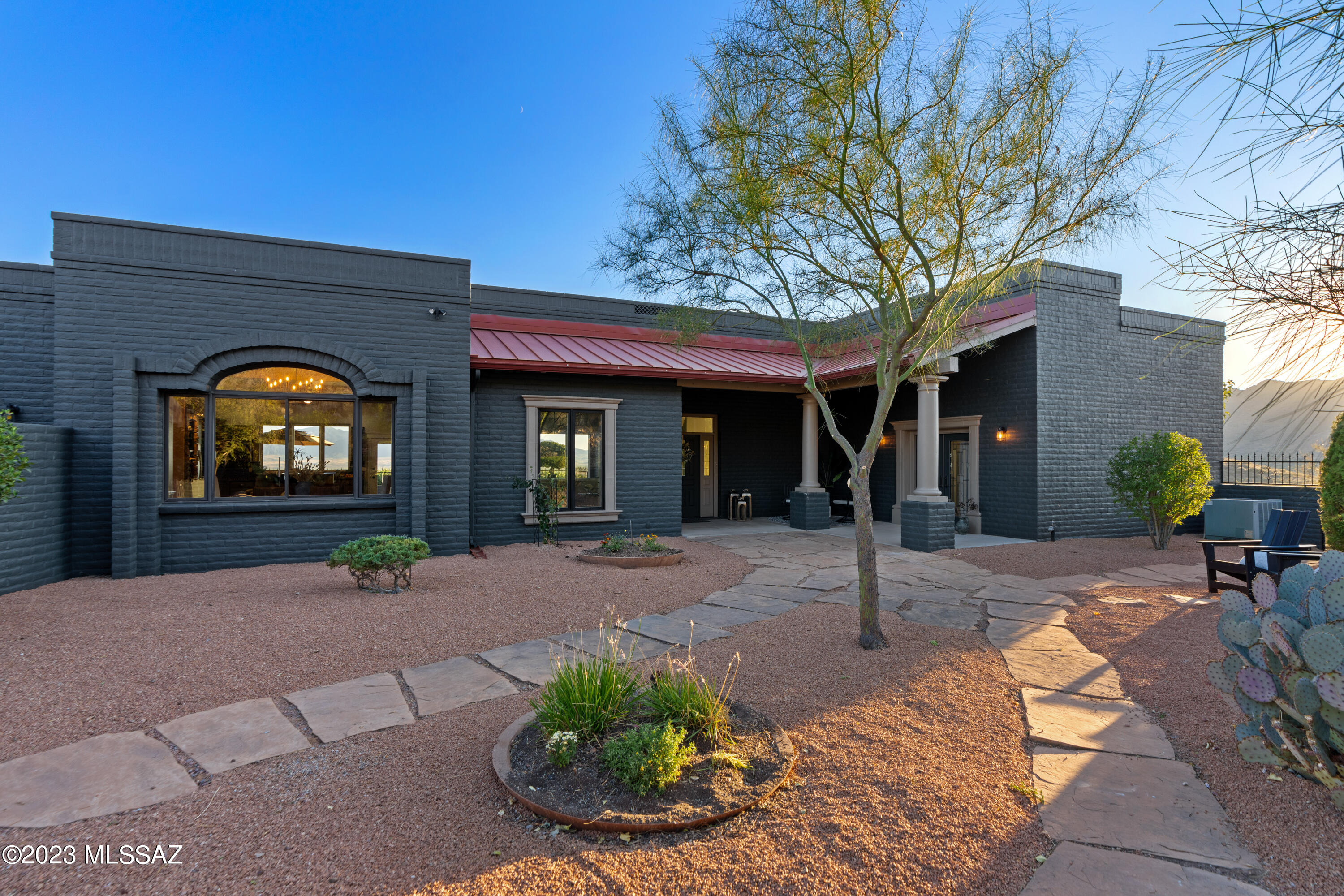 Discover luxury mountain living in an exclusive gated community, sprawled across ~40 acres of serene desert landscape. Marvel at the most breathtaking panoramic views, ensuring every day begins with an inspiring backdrop. Adjacent to state land to the west and a private well, this property promises an uninterrupted natural connection. Wake up to mountain sunrises, and relish sunsets on the multiple patios, all with desert views. Enjoy six+ garage bays for your prize cars and hobbies. Savor 12-foot wood-plank ceilings paired with expansive picture windows, inviting an abundance of natural light. Enjoy maximum privacy, sharing only with abundant wildlife native to Southern Arizona. This majestic haven is not just a home, but a lifestyle for those who demand nothing less than extraordinary.