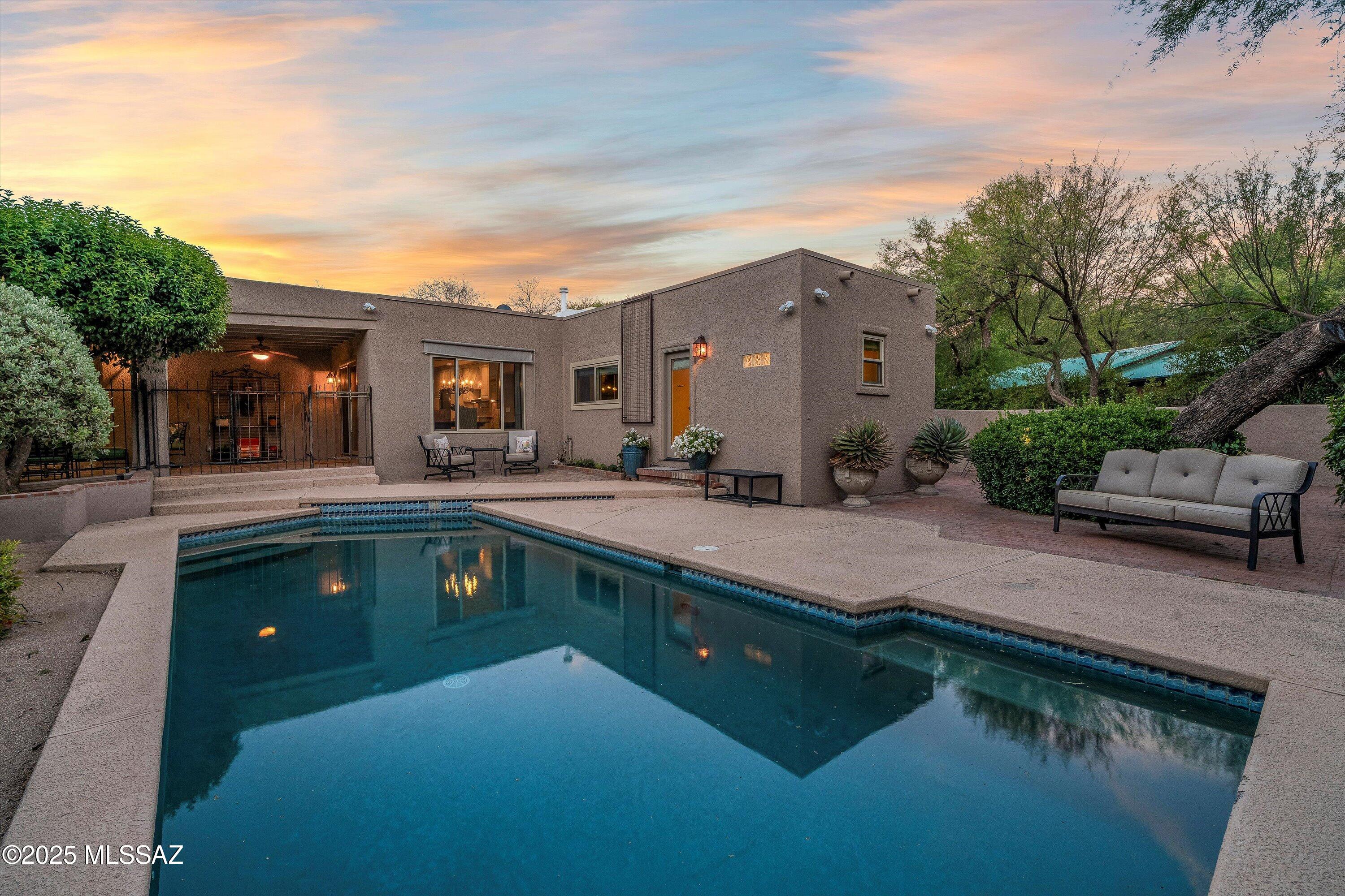 This home has been completely renovated blending classic ranch-style, & modern  upgrades.  This estate includes an adjoining 1.06 acre lot that can be combined or split off to sell.  Perfect for horses, hobbies, or left in it's natural  state. Nestled within a serene grove of mature trees, this picturesque ranch property offers a timeless blend of rustic charm & natural elegance. Private guest quarters w/En-suite bath & French door leading to patio area.  Warm earthy finishes perfectly harmonizing w/ it's serene surroundings. A grand entry w/custom arched wood door sets the stage as you enter the home. An entertainer's dream w/high ceilings accented w/exposed wood beams & a custom  bar connected to the great Rm. Floor to ceiling windows to gaze at the lush green surroundings. Gourmet kitchen features Pot filler for instant hot H20 @ induction stove, double ovens, abundance of 42" raised panel cabinets w/glass door inserts, Lrg. Center Island w/cherry cabinets, granite counters, adjoining casual eating area with a large glass door opening to a covered rear patio & tranquil pool.  Multiple entertainment areas, private patios & lush green surroundings make it easy to find a private spot to relax. 
Owner's suite, with seating area & cozy fireplace, double French doors usher you out to an extended paver patio. New luxury bath retreat w/spacious walk-in shower adorned w/designer tile.  Executive height vanity w/granite counter & large walk-in closet. 
Hall bath has imported Rajah stone accents & Quartz top vanity, custom mirrors & light fixtures & an atrium for added light and plantings.  
Additional features: Two year old HVAC & new Wood clad windows, Travertine stone floors w/staggered brick design, 10x24 storage in rear side yard, RV slab, hook-up including sewer, water & elec. Properties like these are rare, don't miss an opportunity to make this your forever home.