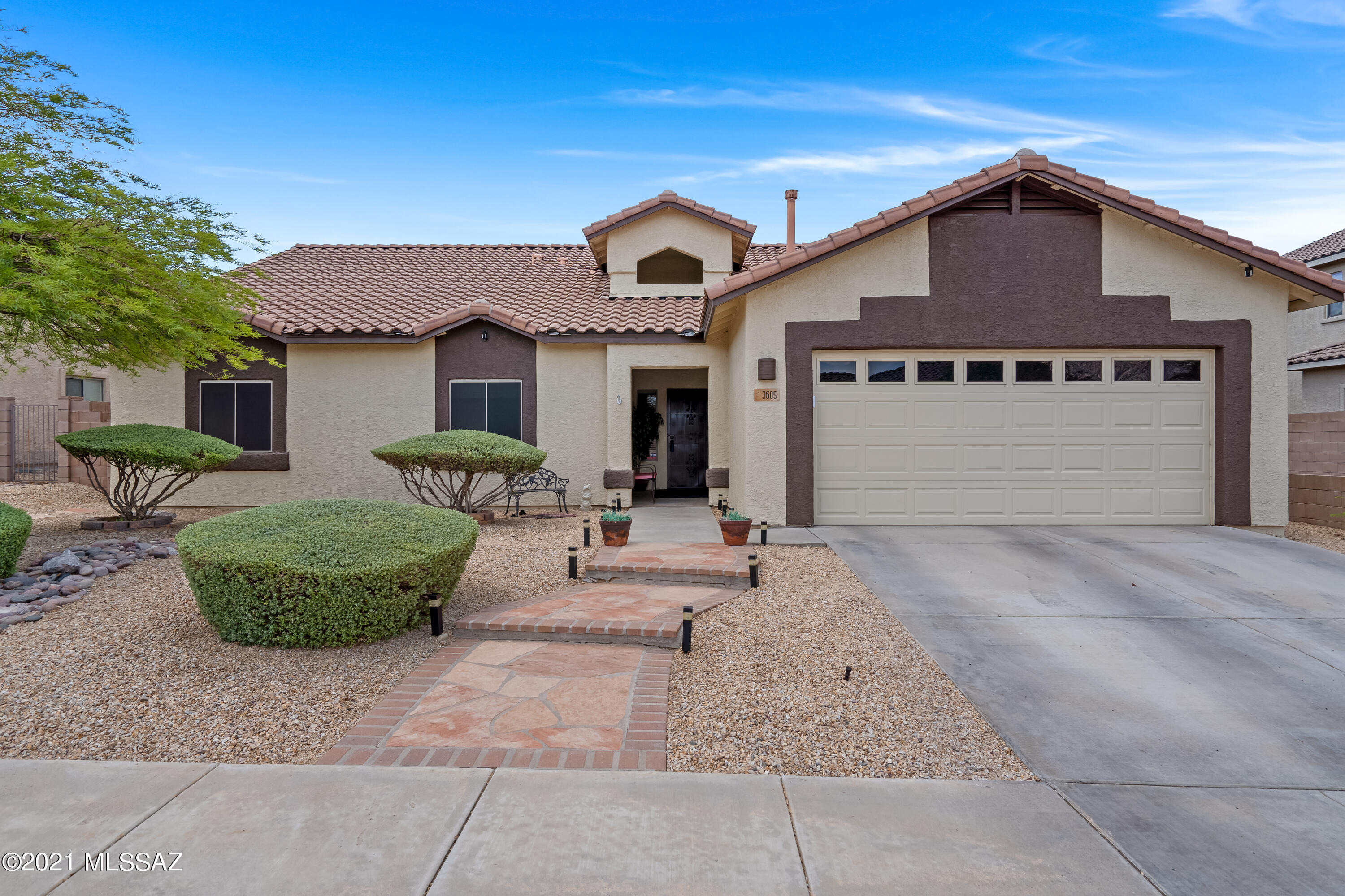 Great opportunity to view this originally owned, lovingly maintained, US Home built in the beautiful Black Horse Ranch subdivision. Large, bright and open floor plan with 4 good-sized bedrooms (3 with walk-in closets) plus a den! Formal dining area in the great room open to the large living space complete with a fireplace and breakfast bar. Cooks delight kitchen includes all new stainless appliances, gas cook-top, pantry closet, utility closet and endless counter space. Freshly painted interior and exterior with neutral colors and low maintenance tile and laminate flooring in the high traffic areas. Newer plush carpet installed in the living area and den. The front and backyard are both professionally landscaped. This home offers extra privacy with an easement to the north and a wash to the east. Fully fenced play pool surrounded by mature vegetation including multiple citrus trees, covered patio with pavers (and a ceiling fan), dog run, and even a hot tub to soak in during the cold winter nights! Energy efficient sun screens installed on every window, hard wired alarm system and a 2 car garage (with all new mechanicals). Easy access to Oracle road, great schools and close to dining and shopping!