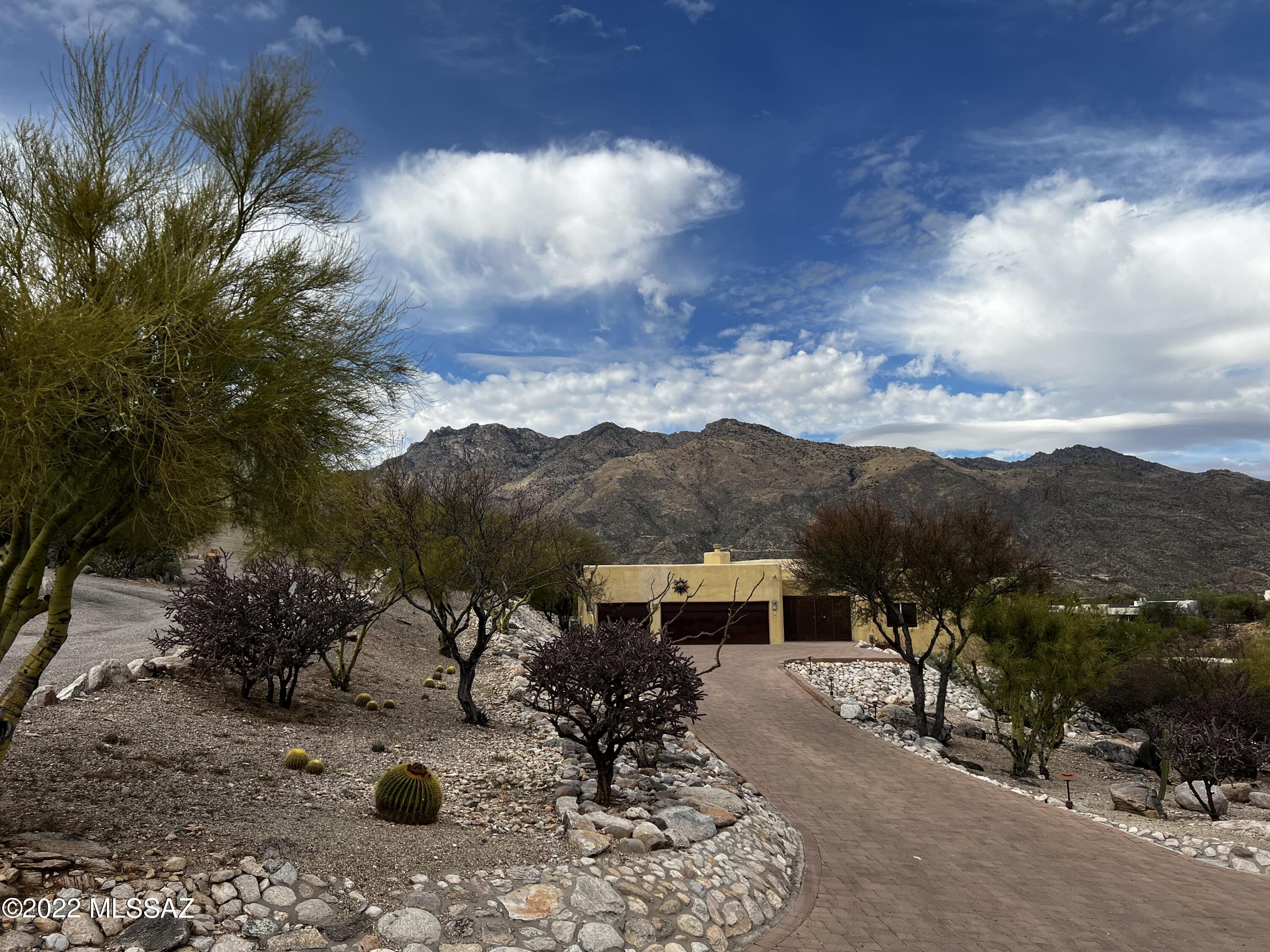 Charming Santa Fe home  located in the popular Northern Tucson community of Cimarron Foothills Estates. The one owner property was inspired by a Southwestern Design.  This custom built family home offers a split bedroom plan, formal living and dining room as well as an eat-in kitchen plus a Family room.  Enjoy the spectacular Catalina mountain views from the refreshing Negative Edge Pebble Tech Pool. The grounds have been landscaped for low care and the backyard overlooks the natural desert and amazing mountain views. North facing covered patio is perfect for year round enjoyment.