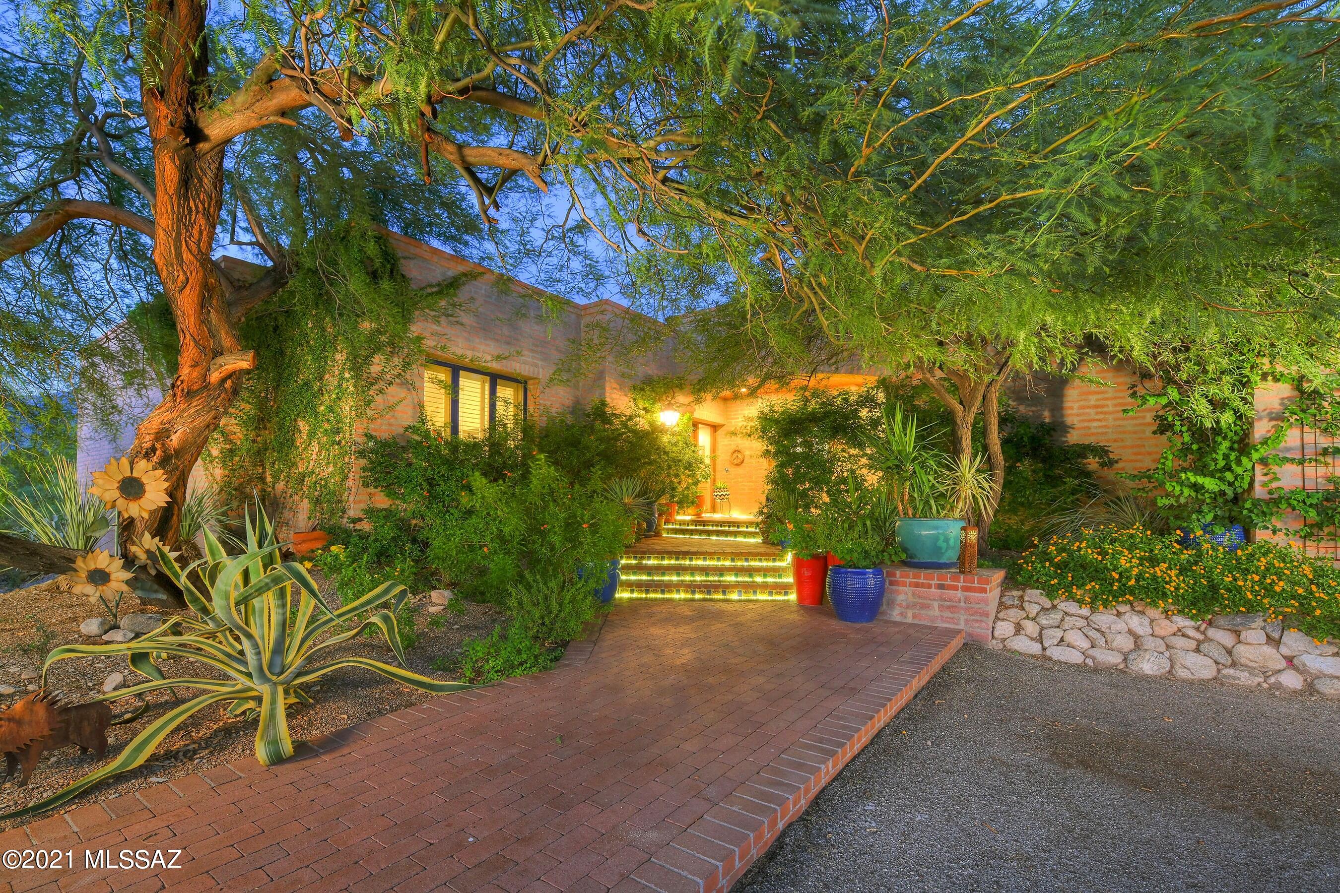 This truly enchanting La Quinta Masterpiece sitting high on a private gated hilltop boasts fabulous mountain views & the most incredible SW charm you can imagine. The lushly vegetated entrance leads you into the dramatic grtrm w/hi beamed ceils, lovely FP & walls of wood cased windows framing the majestic Catalinas. The gorgeous new kitch features Viking 6-burner cktp, Wolf dbl ovens, lg dual temp Sub-Zero wine cooler, quartz cntrs, warming drawer & Miele DW.  Spectacular patio designed for entertaining has gas FP, blt-in BBQ & feels like indoor living space leading out to the architecturally significant lap pool w/ jacuzzi & waterfall.  Retreat to the luxurious Mstr Ste w/sitting area, tons of travertine, spacious glass shower, dual vanity & garden tub w/window to soak in more mtn views.