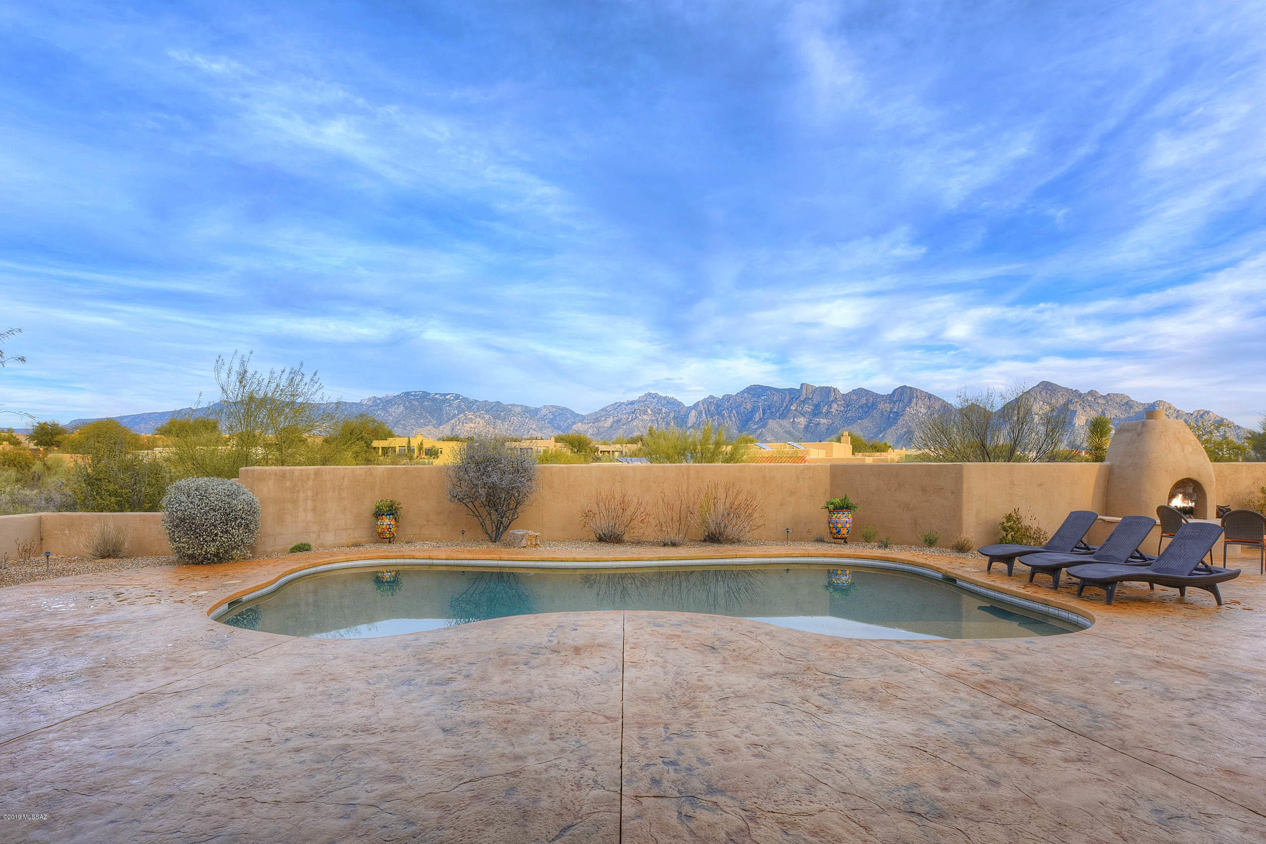 Located in the sought after community of Reflection Ridge, this spectacular home offers single-level living, a split bedroom floorplan, elegant finishes, and expansive mountain views! Outstanding outdoor space with pool/spa, two patios, built-in BBQ, custom fireplace and seating areas. Gorgeous picture windows, coved ceilings in entryway/great room, wet bar, built-in shelving, two fireplaces, and ample room for living/dining. Well-appointed eat-in kitchen featuring stainless steel wall ovens and large island with gas range. Generously sized owner's suite with private entry to backyard and relaxing ensuite bath featuring a garden tub and large walk-in shower with custom tilework and stone floor. Oversized 3-car garage with separate 10 x 10 storage room offers additional storage/workspace.