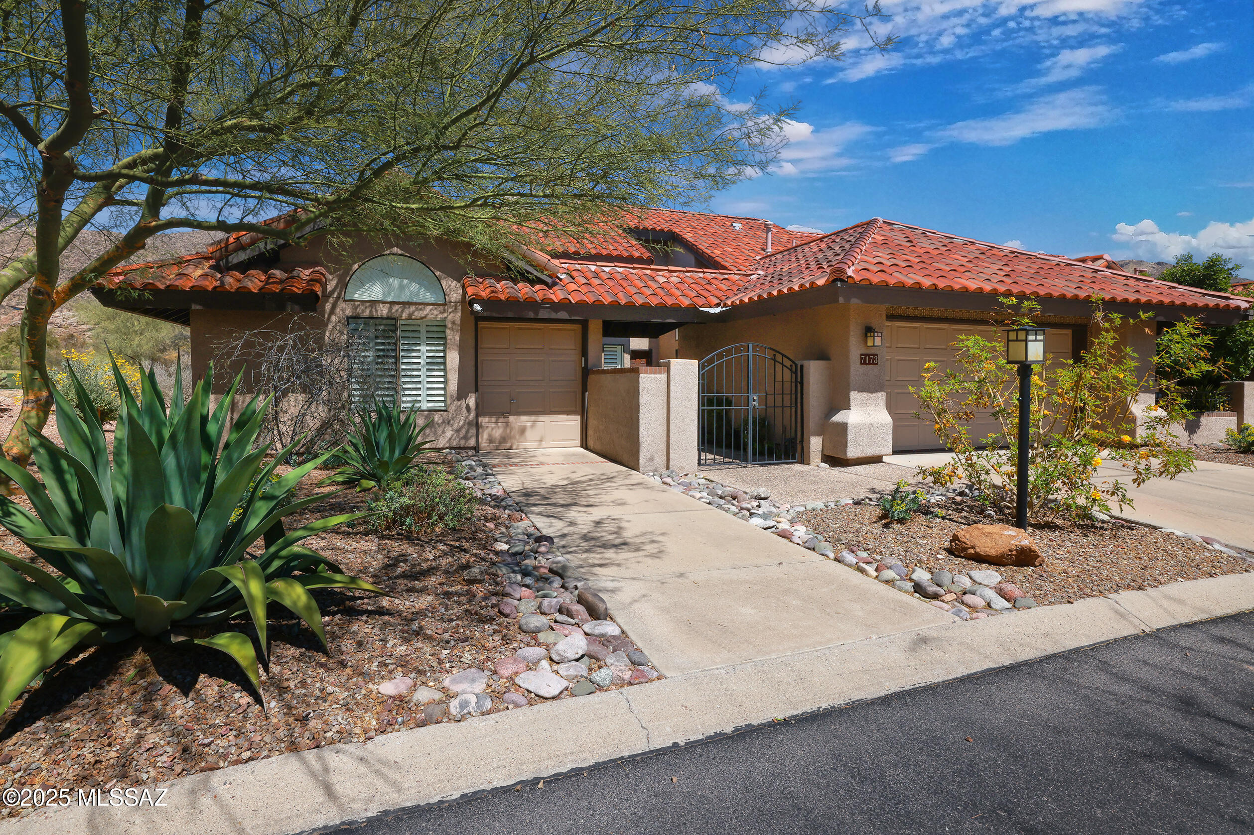 A Year in the Waiting... now is your opportunity to live in the sophisticated Ventana Canyon Lake Estates, a small distinctive Enclave, nestled in the larger estates of Ventana Canyon. This lovely home sits on the 5th Fairway. Your entrance is through a private courtyard with cascading fountain and native shrubs. The home boasts vaulted ceilings, an accent-stained glass windows, built-in wall units, banco seating, and floor-to-ceiling windows that open your view to the Catalina mountains. The beautiful kitchen with Granite countertops has exquisite wood cabinetry, ample storage, a breakfast bar, and a breakfast nook. The Expansive primary suite has large picture windows to the garden, a spacious bathroom with a jetted tub, and a walk-in steam shower. The extensive coverage by the HOA