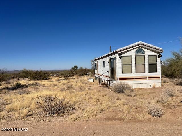Estate Sale. Sold as Land Only with an un-affixed mobile home with all utilities - City Water, Septic, Electric. 
Buy the House and Workshops across the street, too - MLS 22503125
Sold AS IS and Mobile Home sold as personal property only. 

Cash Only.